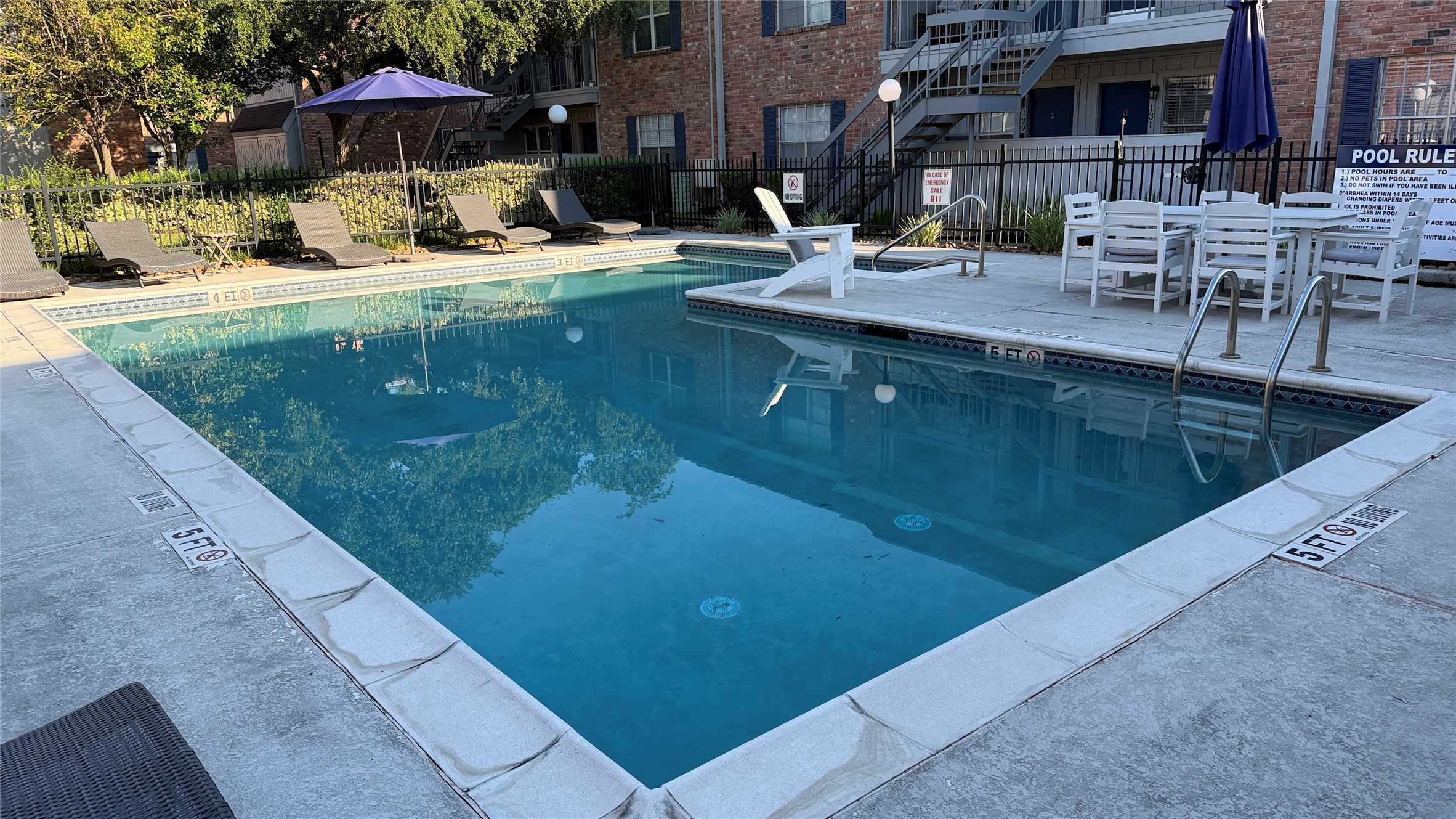 Enjoy the community swimming pool surrounded by lounge seating and outdoor gathering areas.
