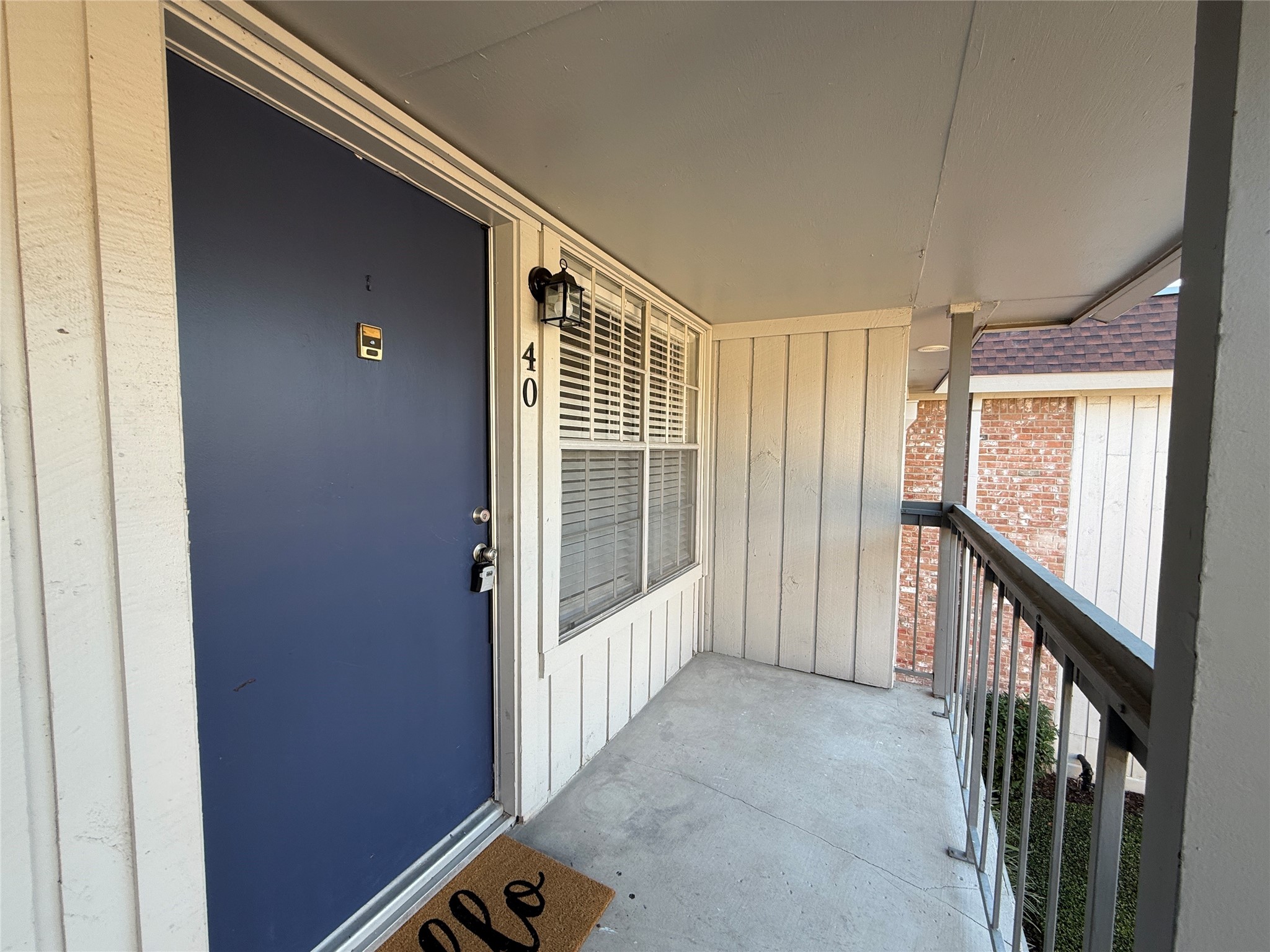 Covered second-floor balcony overlooking the landscaped courtyard, offering a welcoming outdoor space.