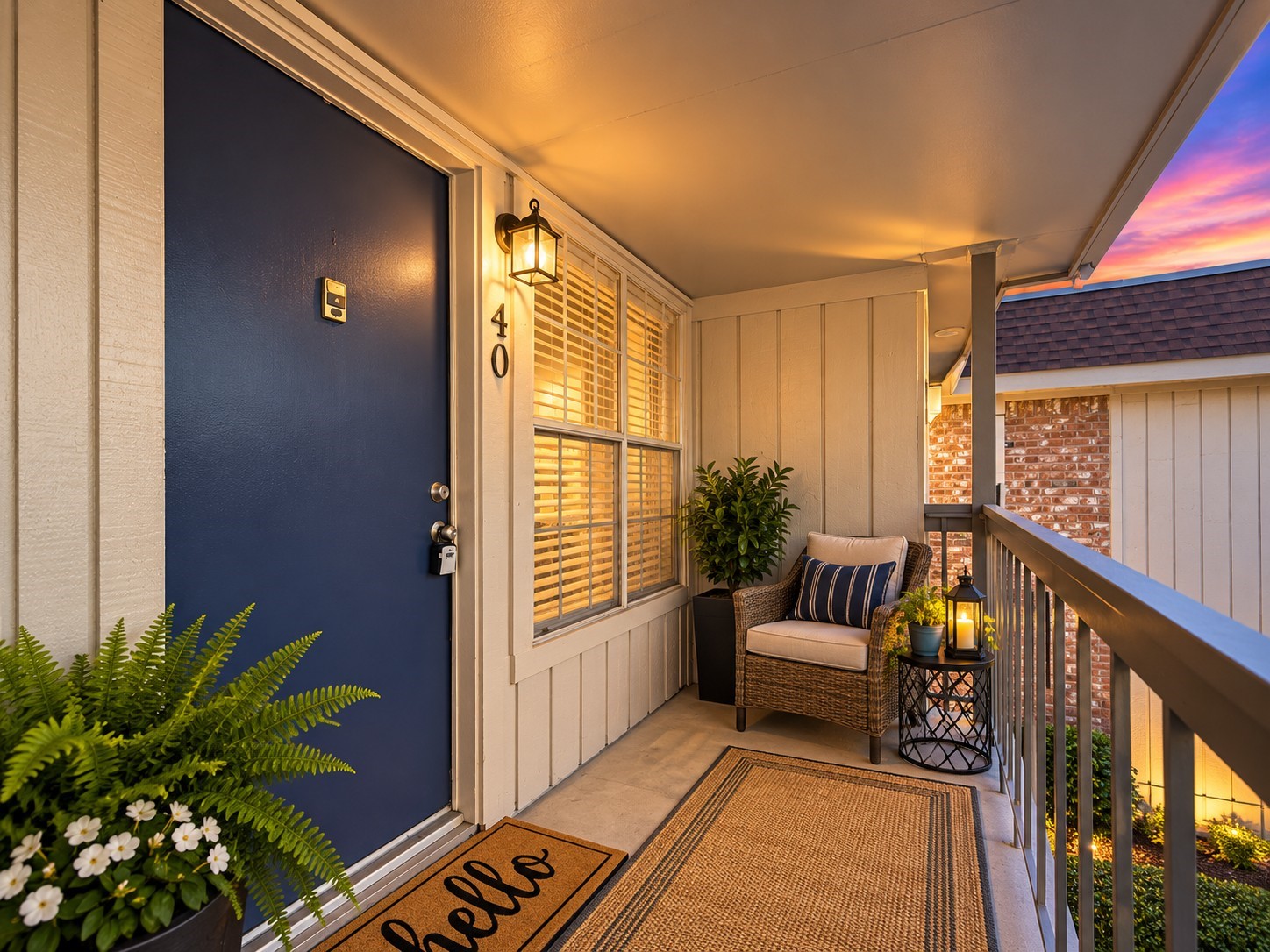 Shared Balcony  Twilight Enhanced: Welcoming second-floor entry with a covered, shared balcony overlooking the community surroundings. Twilight-enhanced photography highlights the inviting atmosphere.