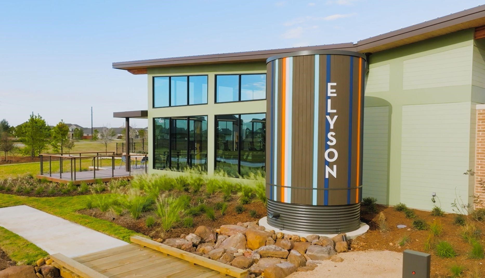 Modern amenity center in Elyson, designed with contemporary architecture, expansive glass walls, and outdoor gathering spaces overlooking the communitys landscaped greenbeltsreflecting the thoughtfully planned lifestyle this award-winning Katy community is known for.