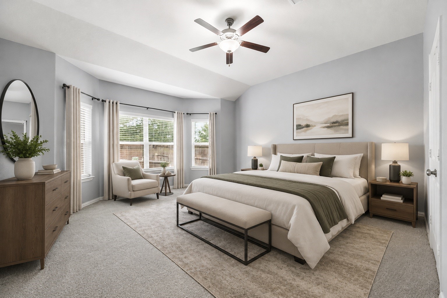 Tucked away on the main level for ultimate homeowner privacy, the serene primary bedroom retreat features a gorgeous multi-window bay alcove overlooking the grounds. Virtually staged.