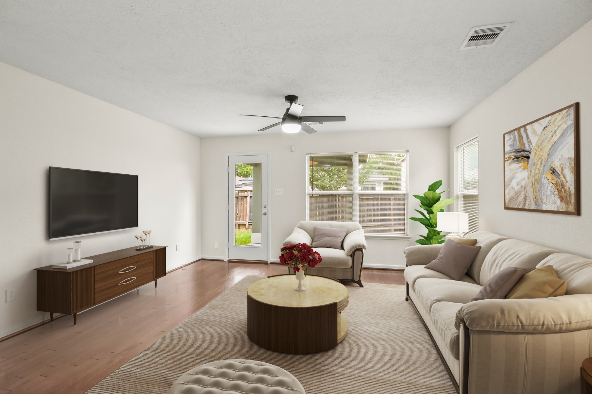 Virtually Staged: This cozy living room features beautiful wood floors, a ceiling fan, and beautiful views of the backyard are provided by large windows. Virtually Staged: This cozy living room features beautiful wood floors, a ceiling fan, and beautiful views of the backyard are provided by large windows.