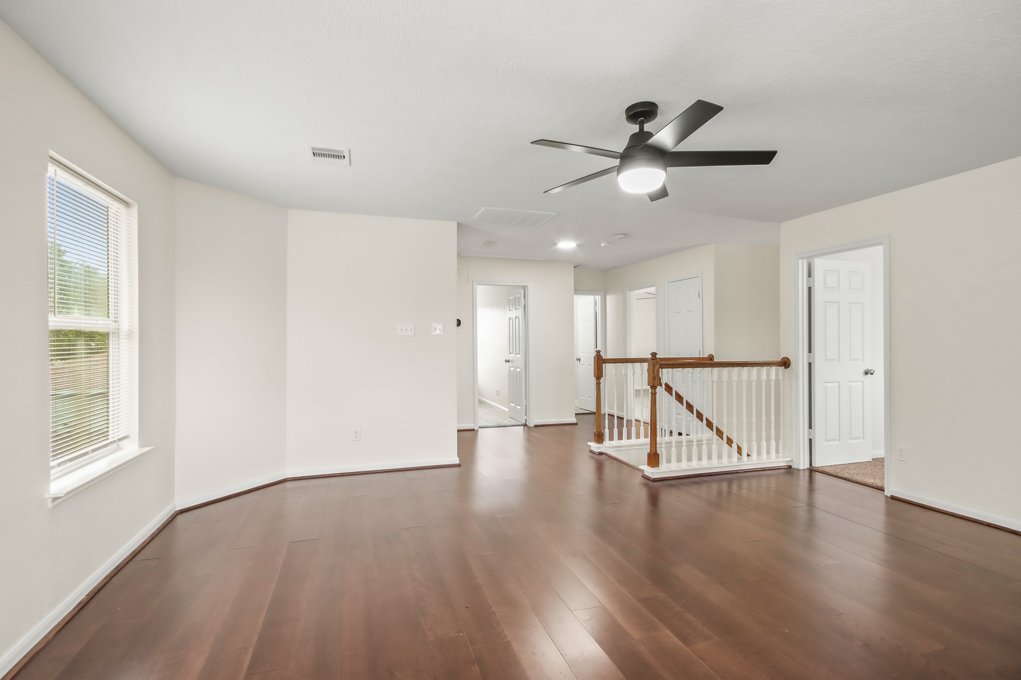 This spacious and versatile flex room has rich wood flooring, neutral walls, and abundant natural light. It is perfect for a kids playroom or unique adult hangout, the options are endless!