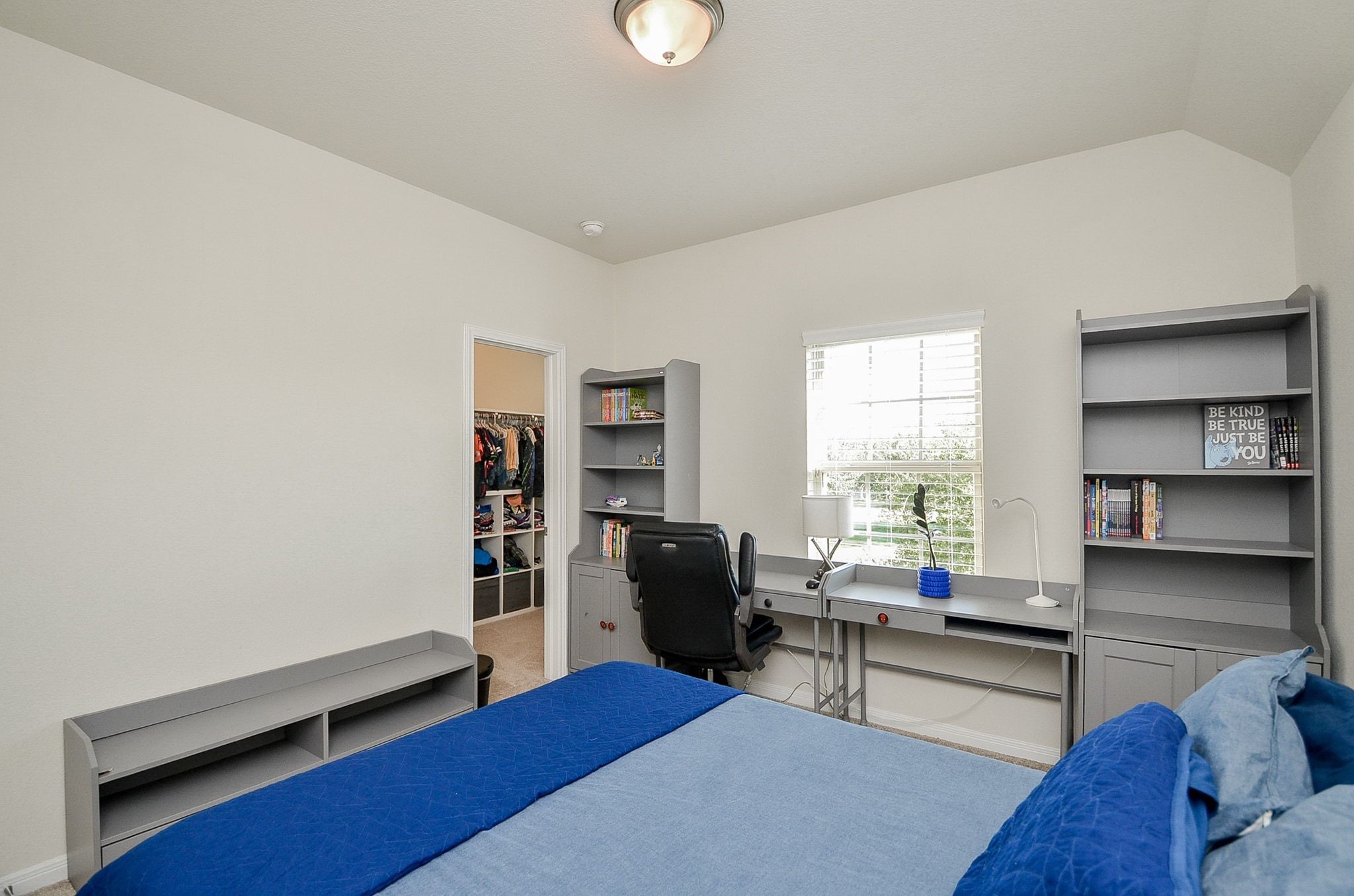Another view of the secondary bedroom featuring a walk-in closet.