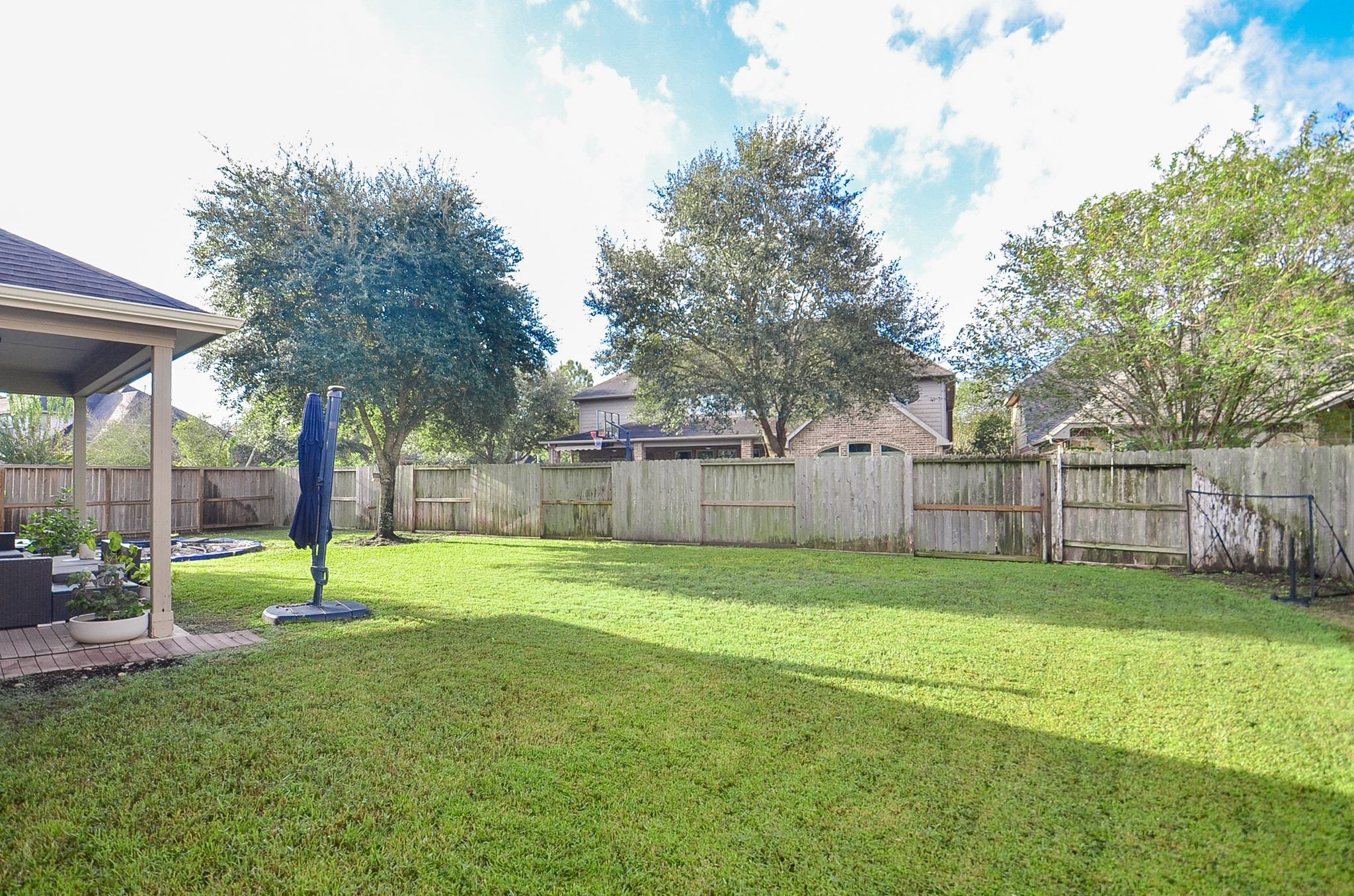 Expansive backyard with mature trees and plenty of room for outdoor activities.