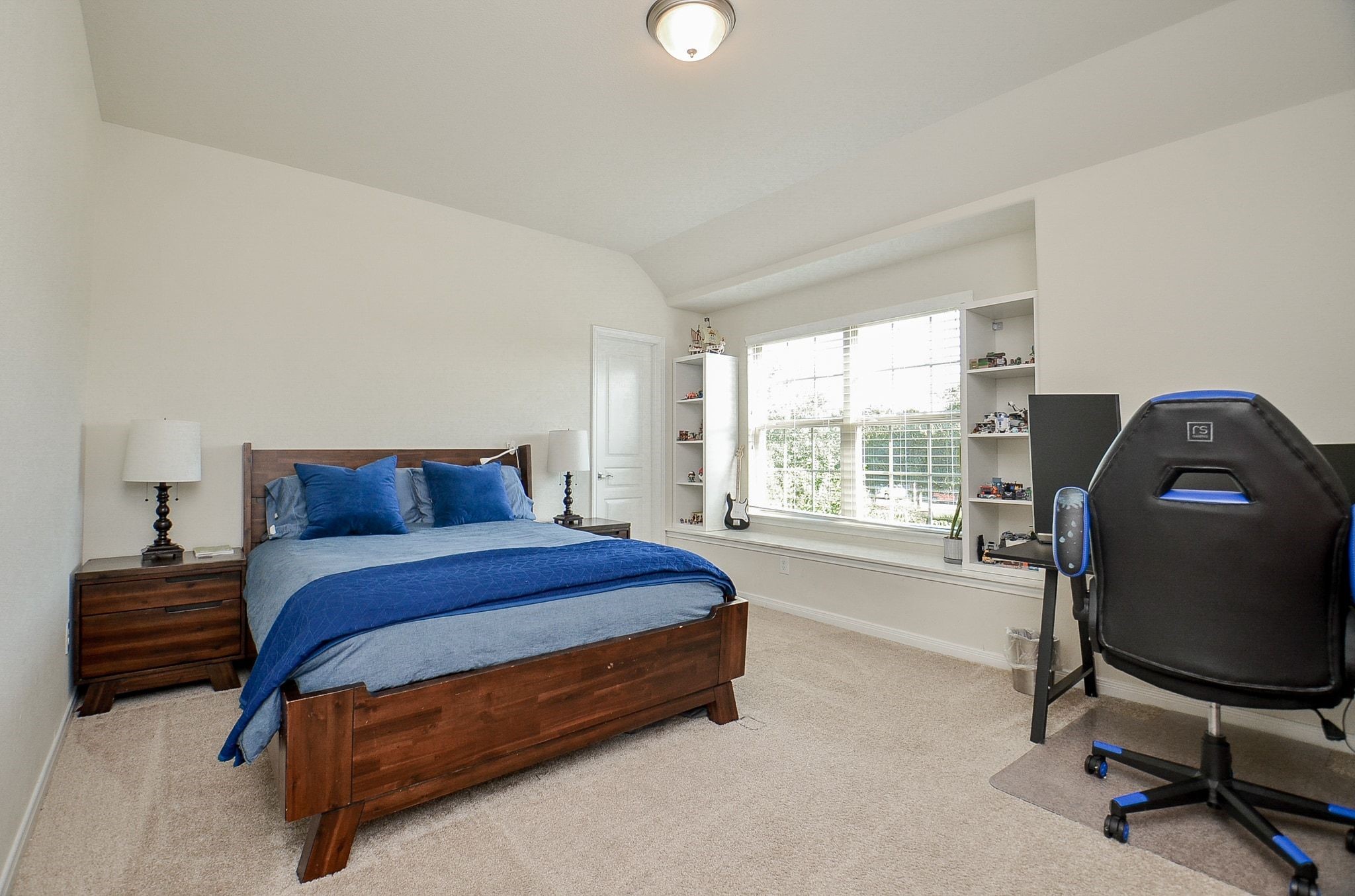 Another bright secondary bedroom with a charming window seat and space for a desk.