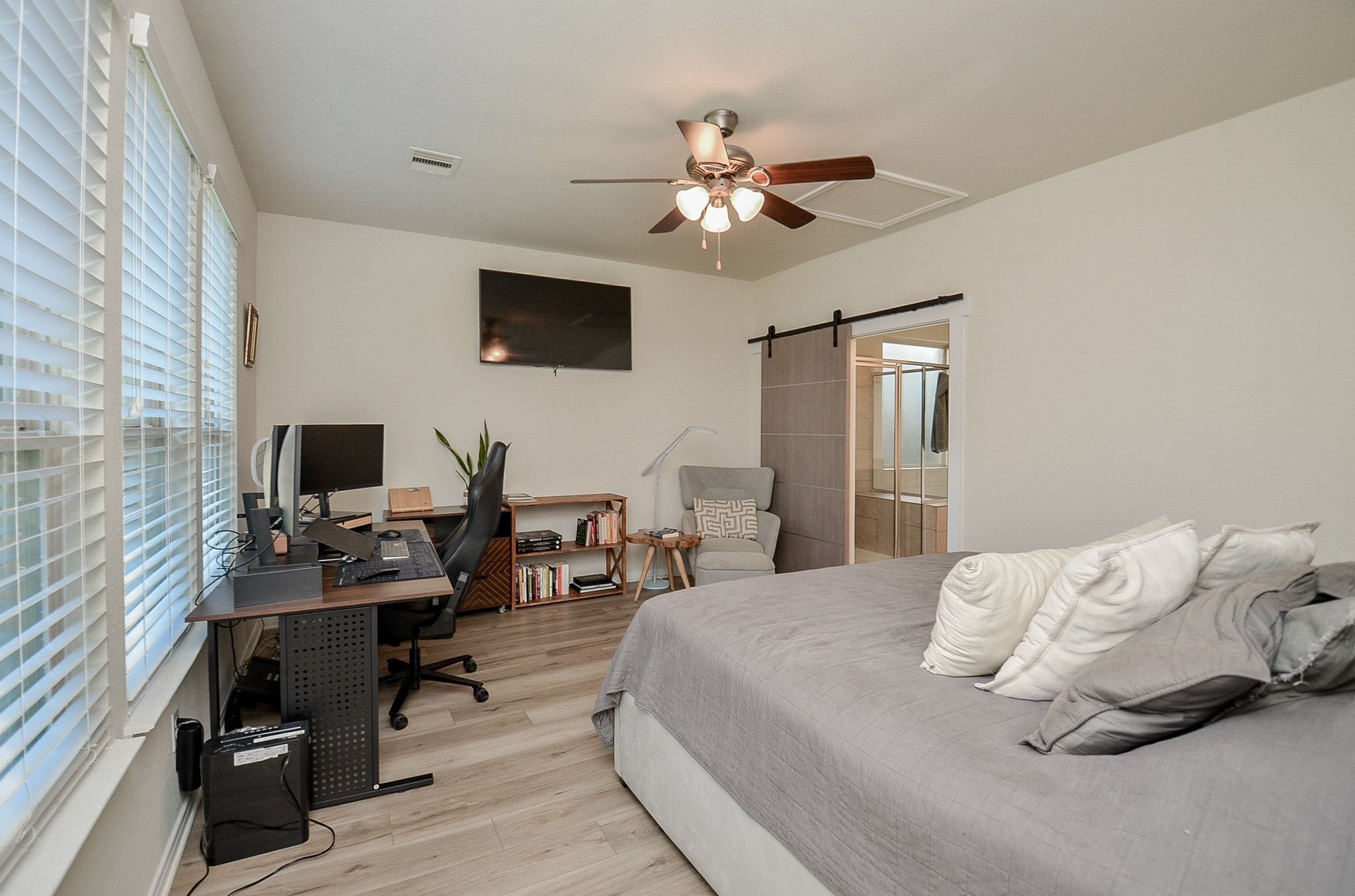 Spacious primary bedroom with abundant natural light and room for a sitting area or a home office.