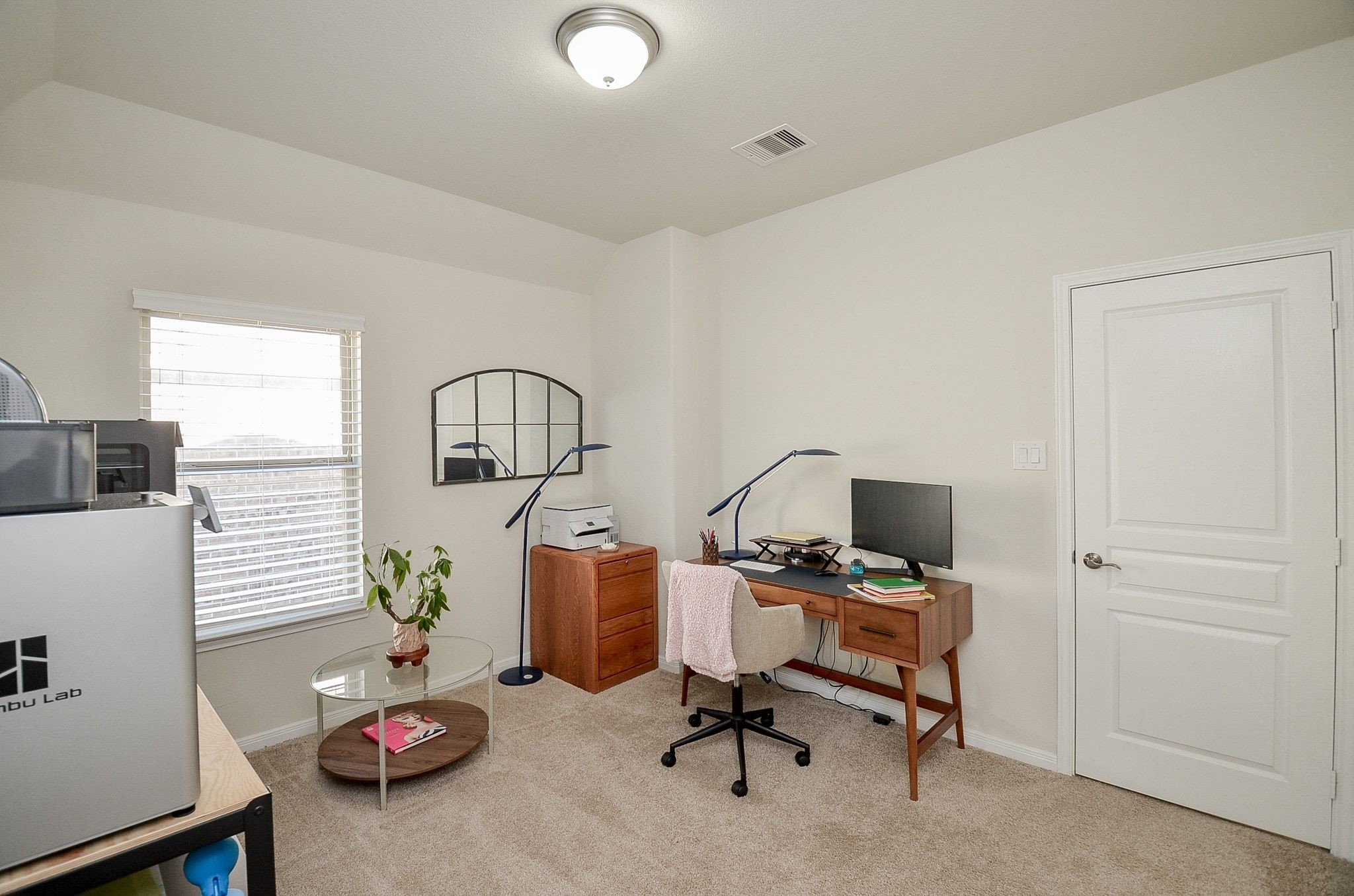 Another secondary bedroom currently used as a home office, ideal for work or hobbies.