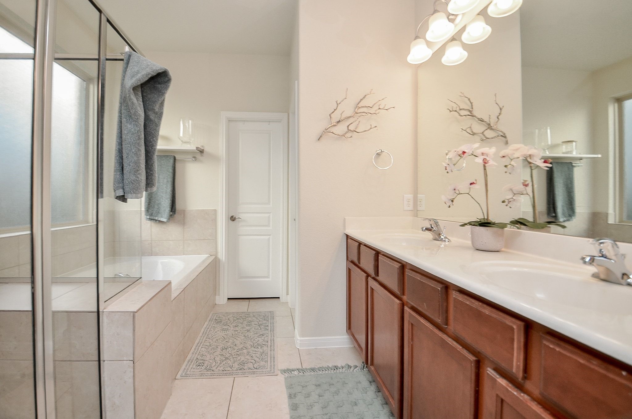 Additional view of the primary bathroom with eparagte shower and soaking tub.