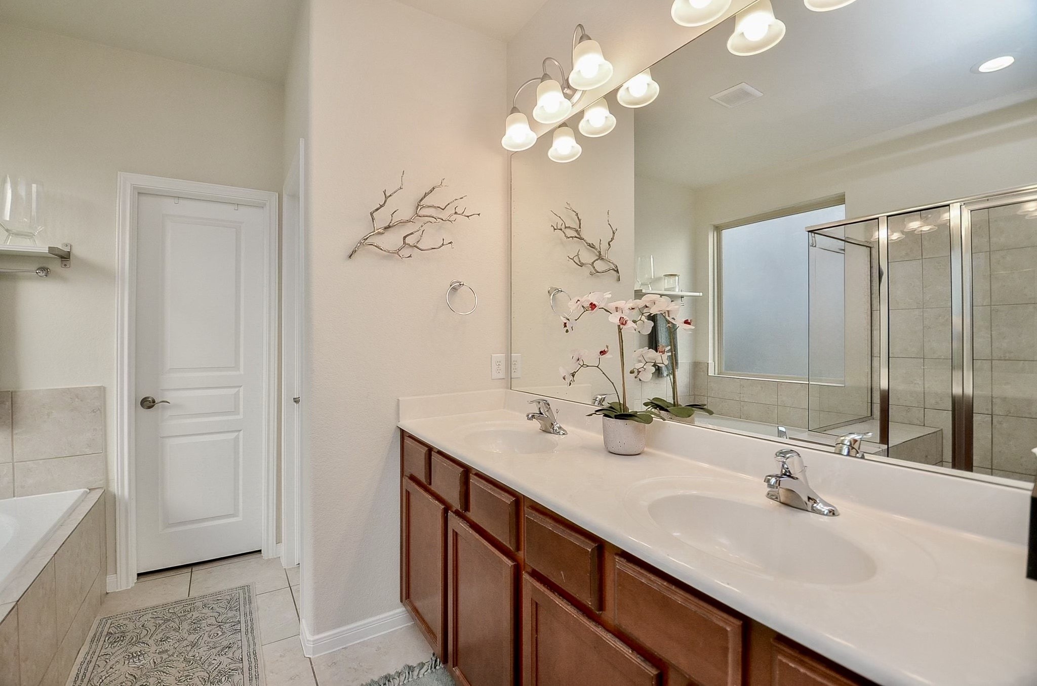 Primary bathroom with dual sinks and ample counter space.