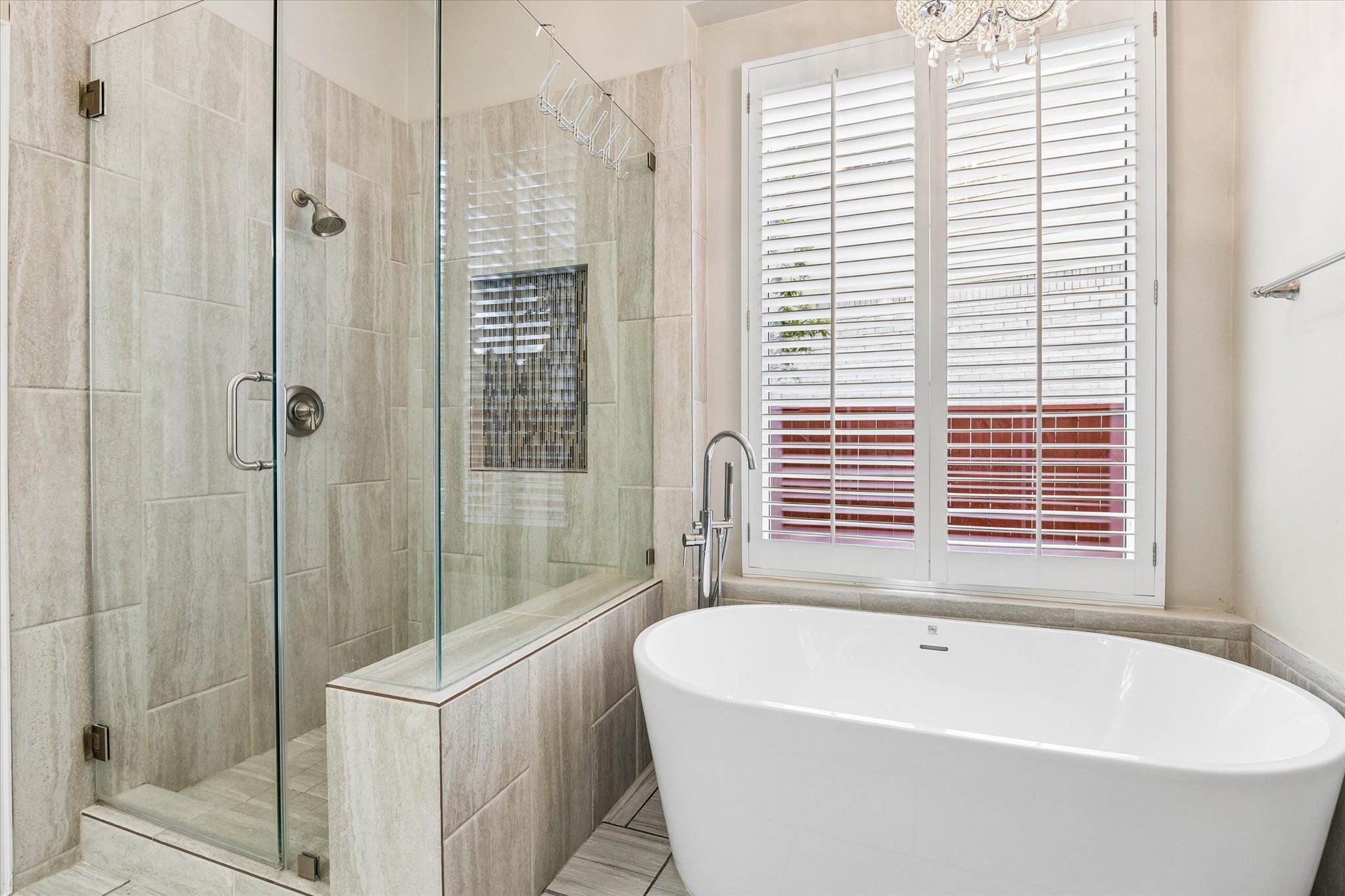 Modern shower and jetted tub. Notice updated lighting throughout the home
