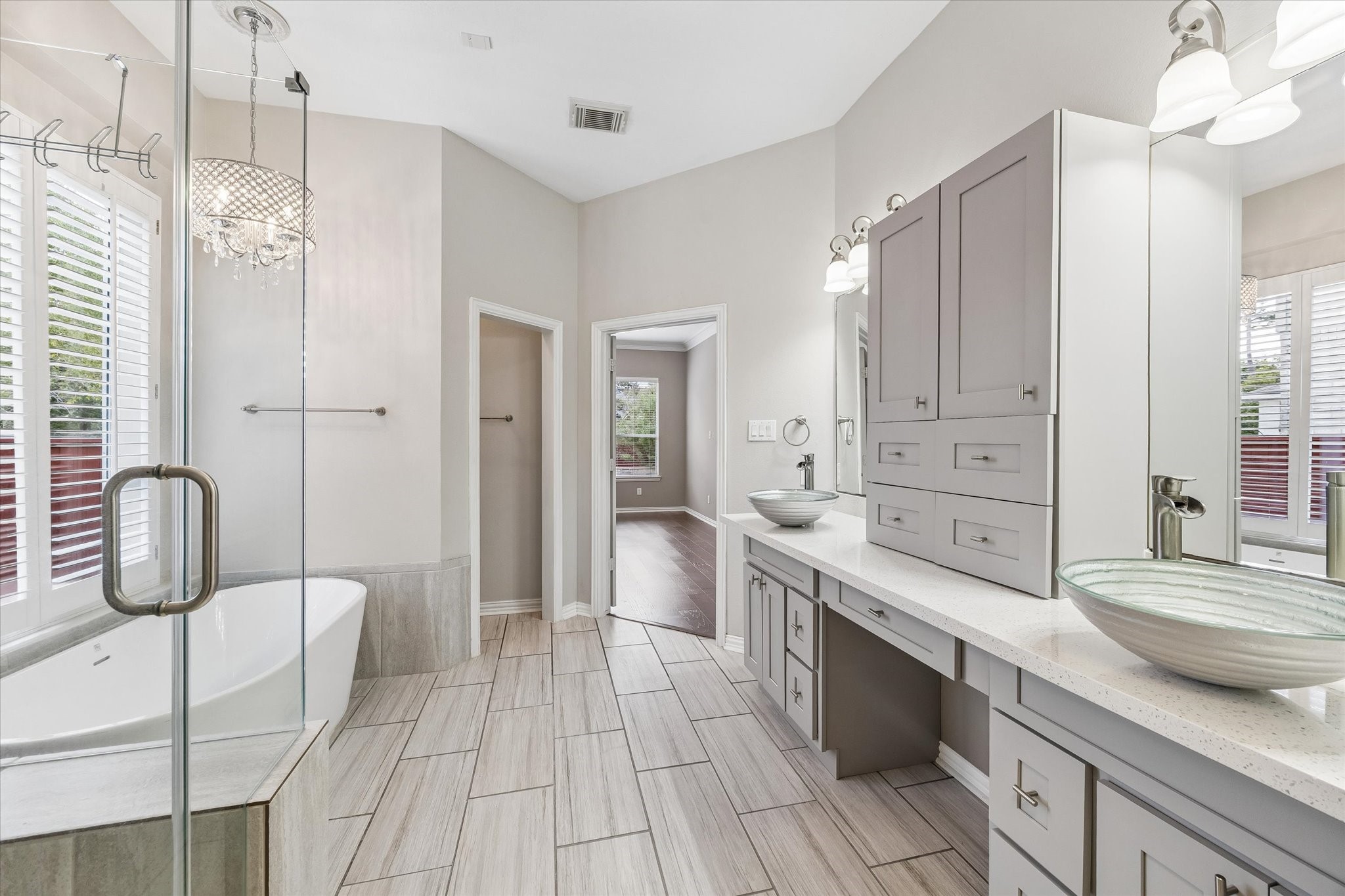 Sleek updated primary bath with updated light fixtures