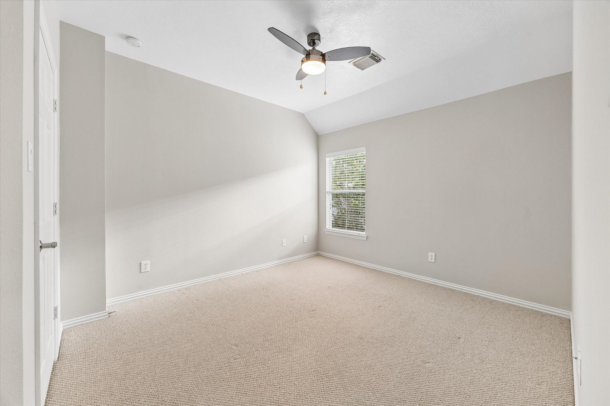 Third of three secondary bedrooms upstairs. All bedrooms have ceiling fans.