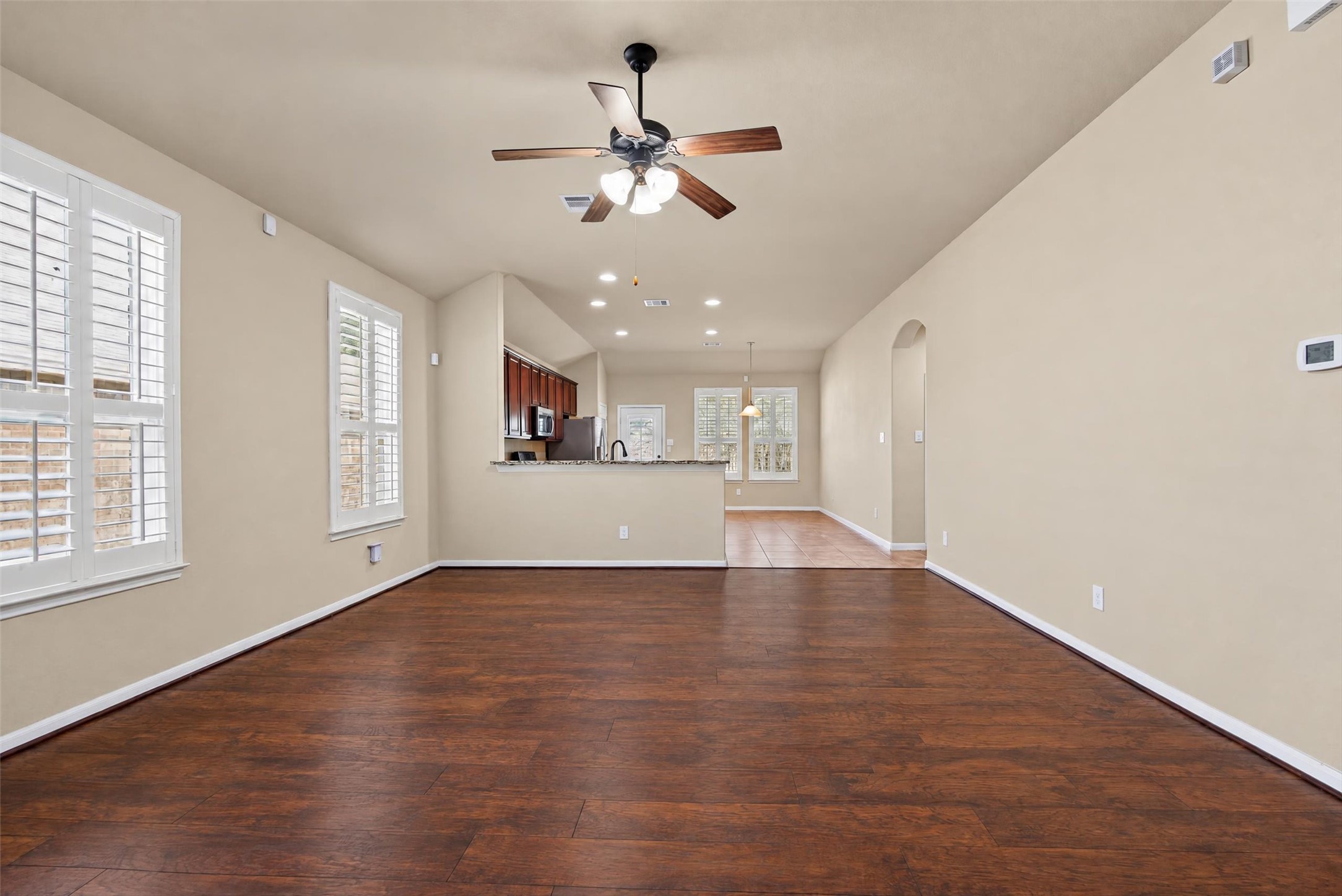 The den flows beautifully into the kitchen.  Perfect for entertaining! Note the amazing plantation shutters!