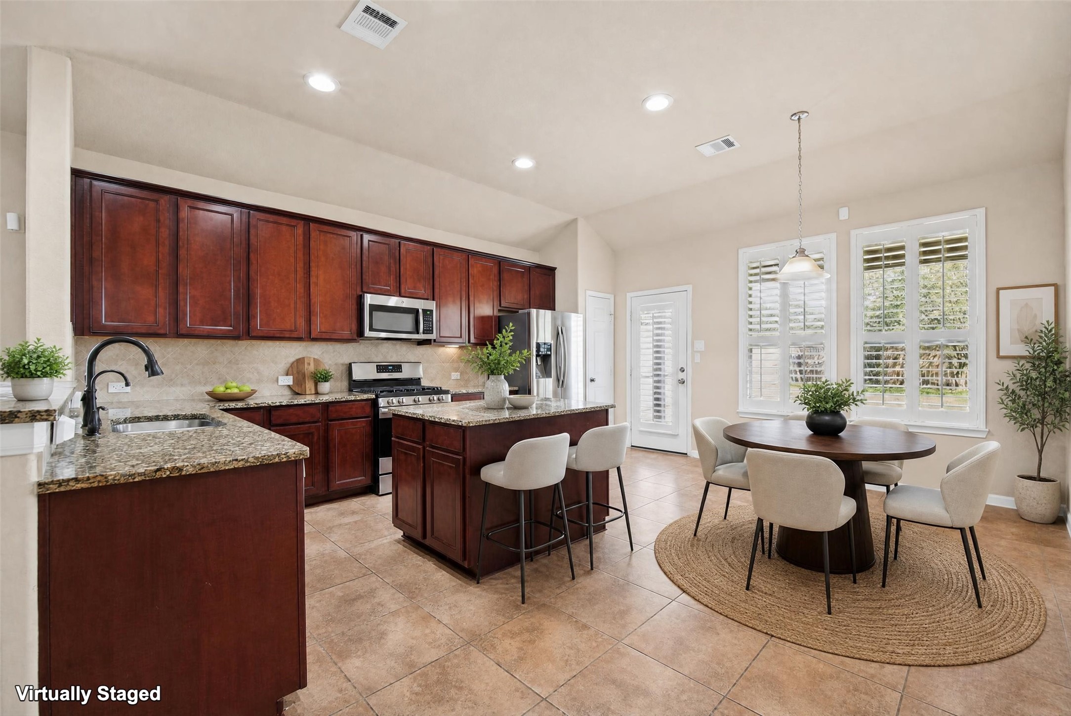 Virtually staged kitchen.  Notice the beautiful plantation shutters!