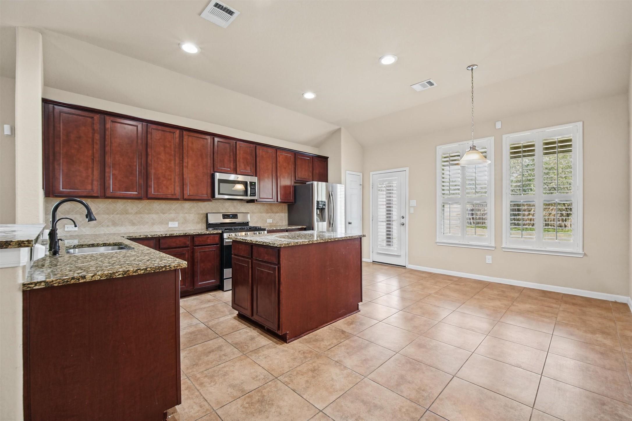 Large kitchen has plenty of cabinets for storage and plenty of counter space for food while entertaining!