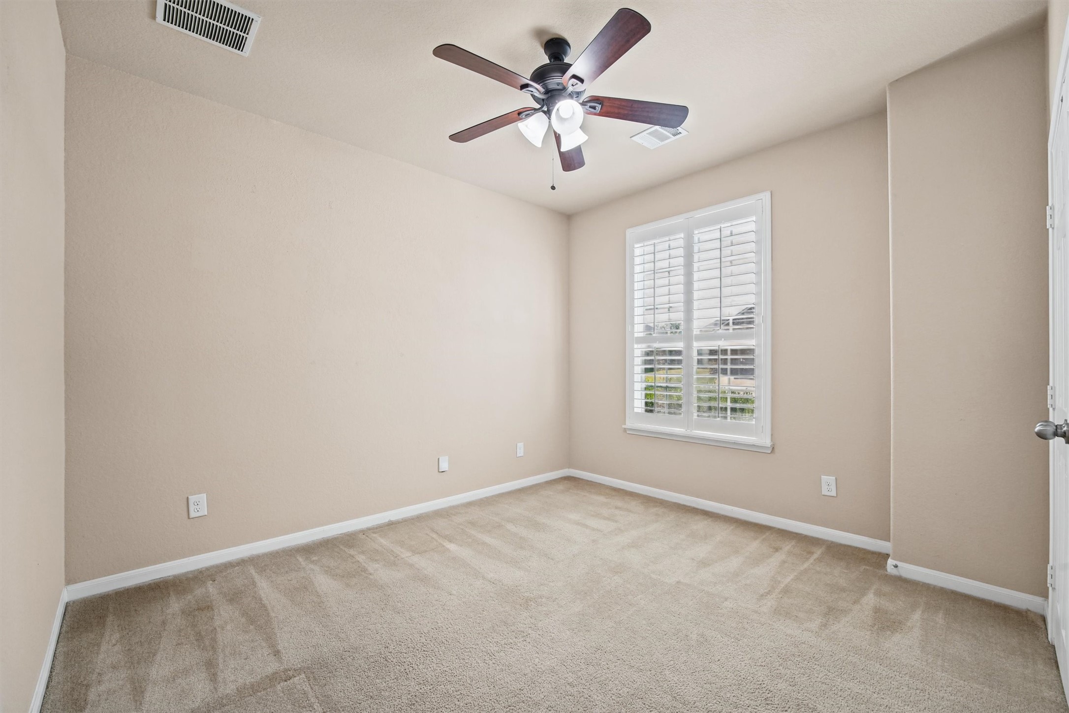Bedroom 2- note carpet and plantation shutters.
