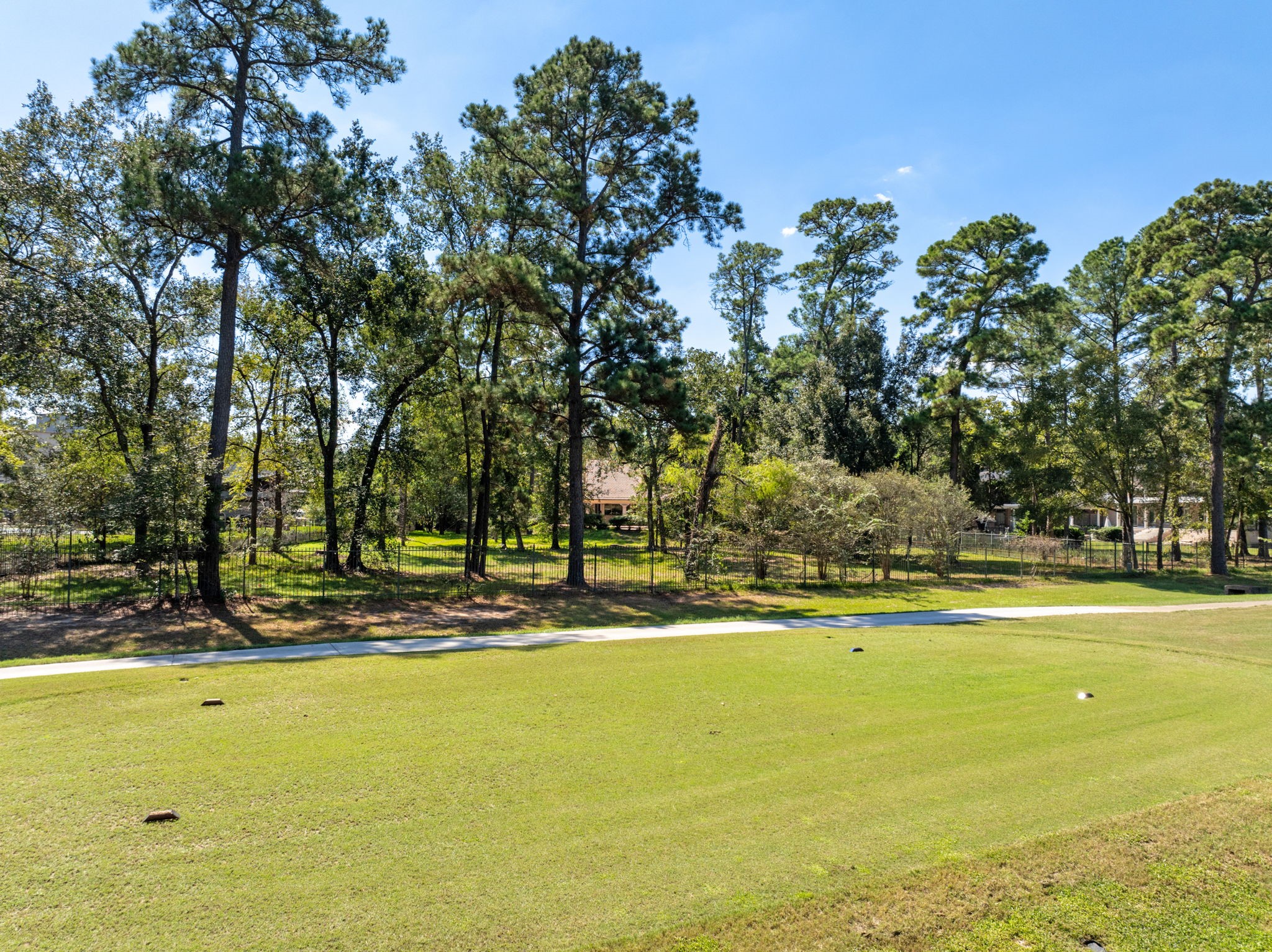 View from golf course to the backyard of this 1.4 acre lot.
