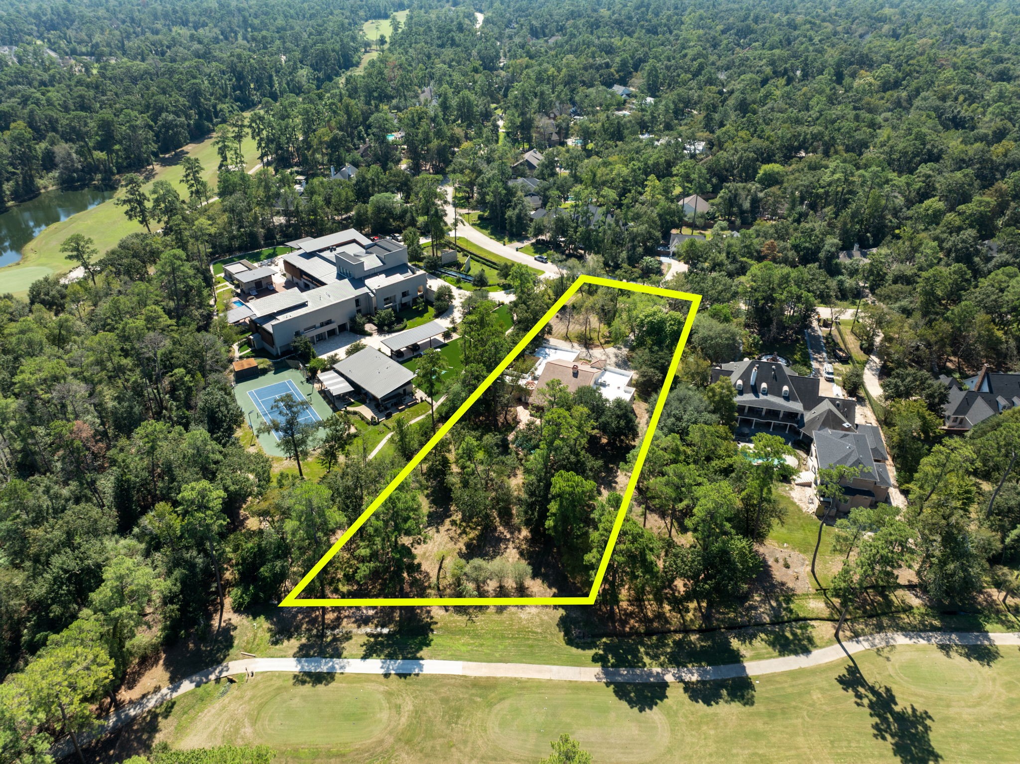 This expansive 1.4-acre lot in the prestigious Grogan's Point neighborhood offers a premier location directly on the Oaks Golf Course, providing the perfect blank slate for your custom dream home.