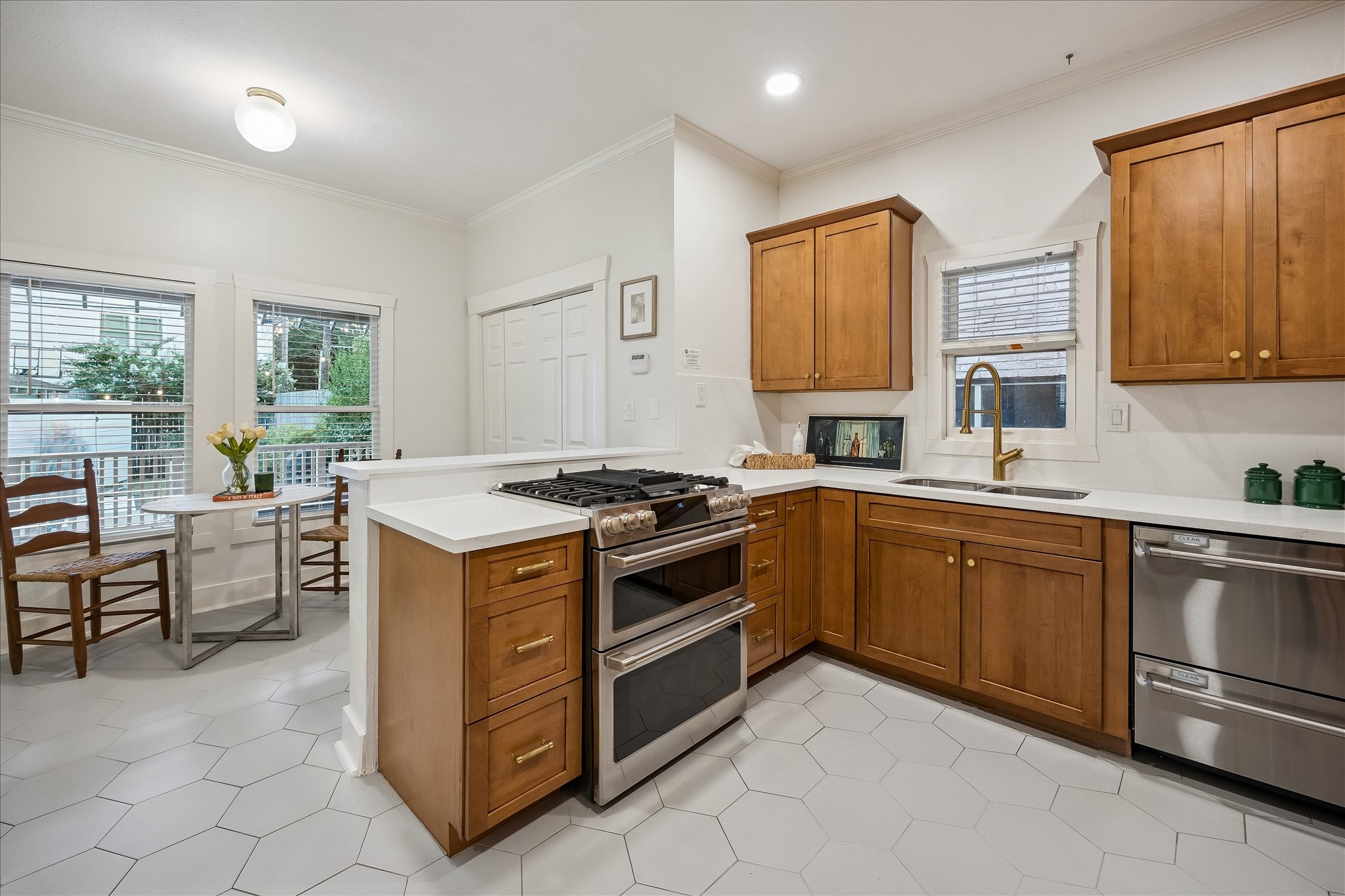 Kitchen and breakfast area with updated tile floors and GE Caf appliances (range, oven, and dishwasher) installed in 2023. Kitchen and breakfast area with updated tile floors and GE Caf appliances (range, oven, and dishwasher) installed in 2023.