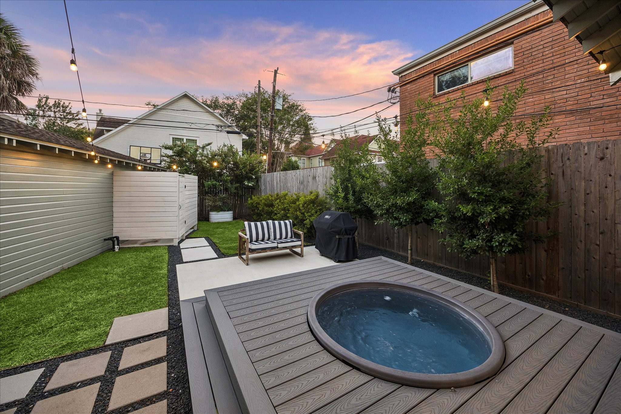 Meticulously landscaped, this backyard layout makes the most of the space with the extended porch featuring the above ground "cowboy pool" (with filter & temp control. All equipment conveys), as well as the outdoor shower.