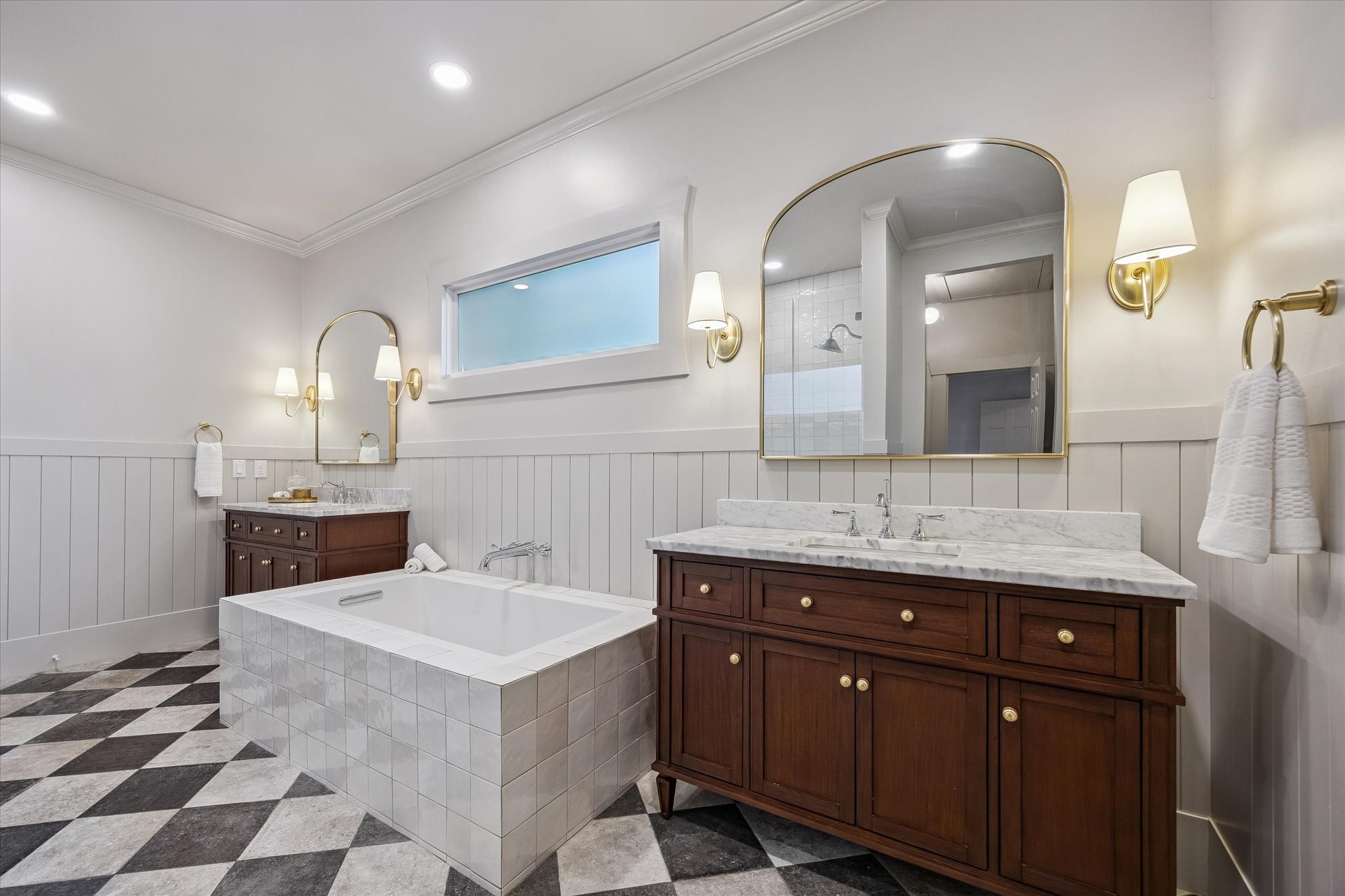 Another view of the dual vanities with designer lighting & soaking tub.