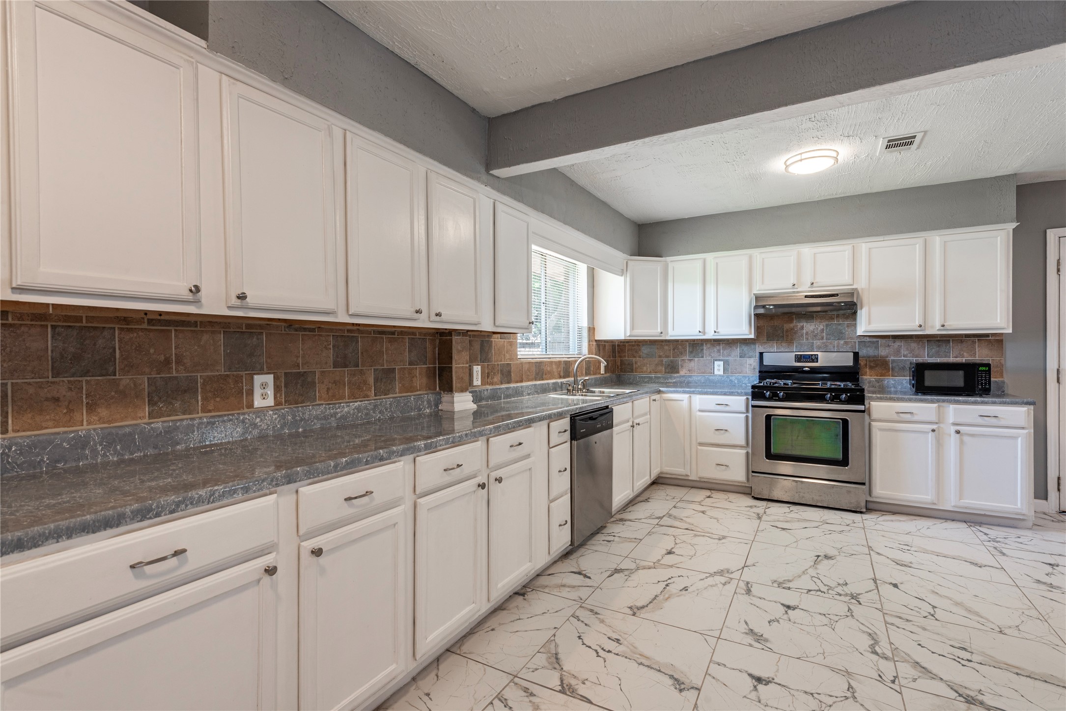*Cabinets have been painted a dark gray.