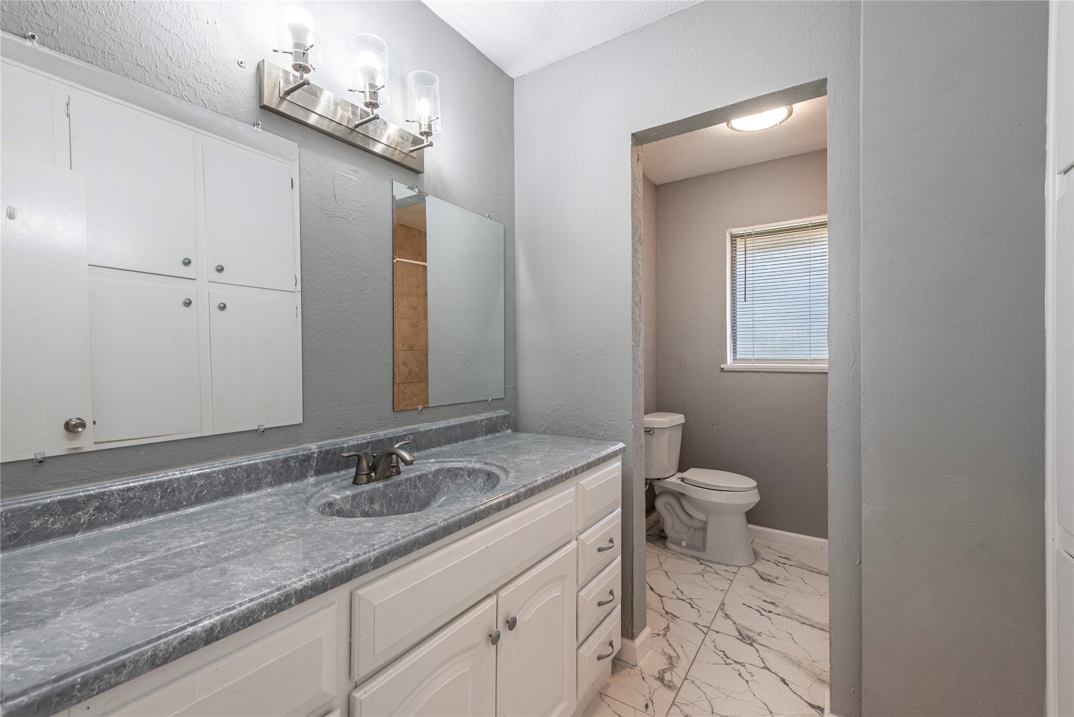 *Cabinets have been painted a dark gray. Secondary bathroom