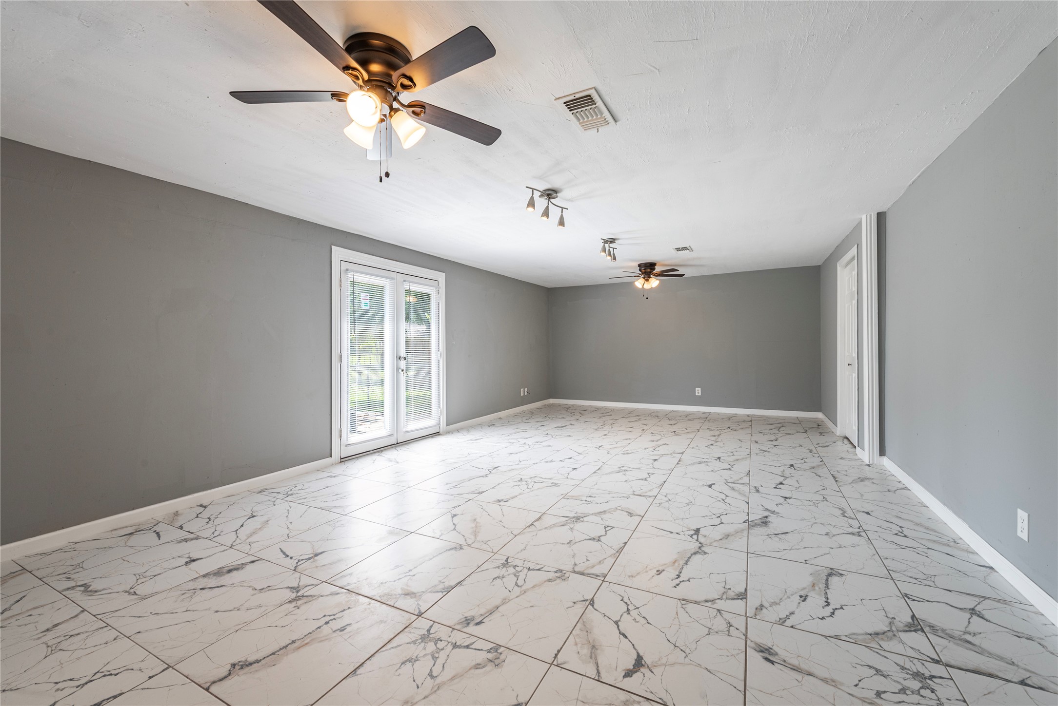 This extra space is perfect for a game room or second living space. It exits to the back patio.