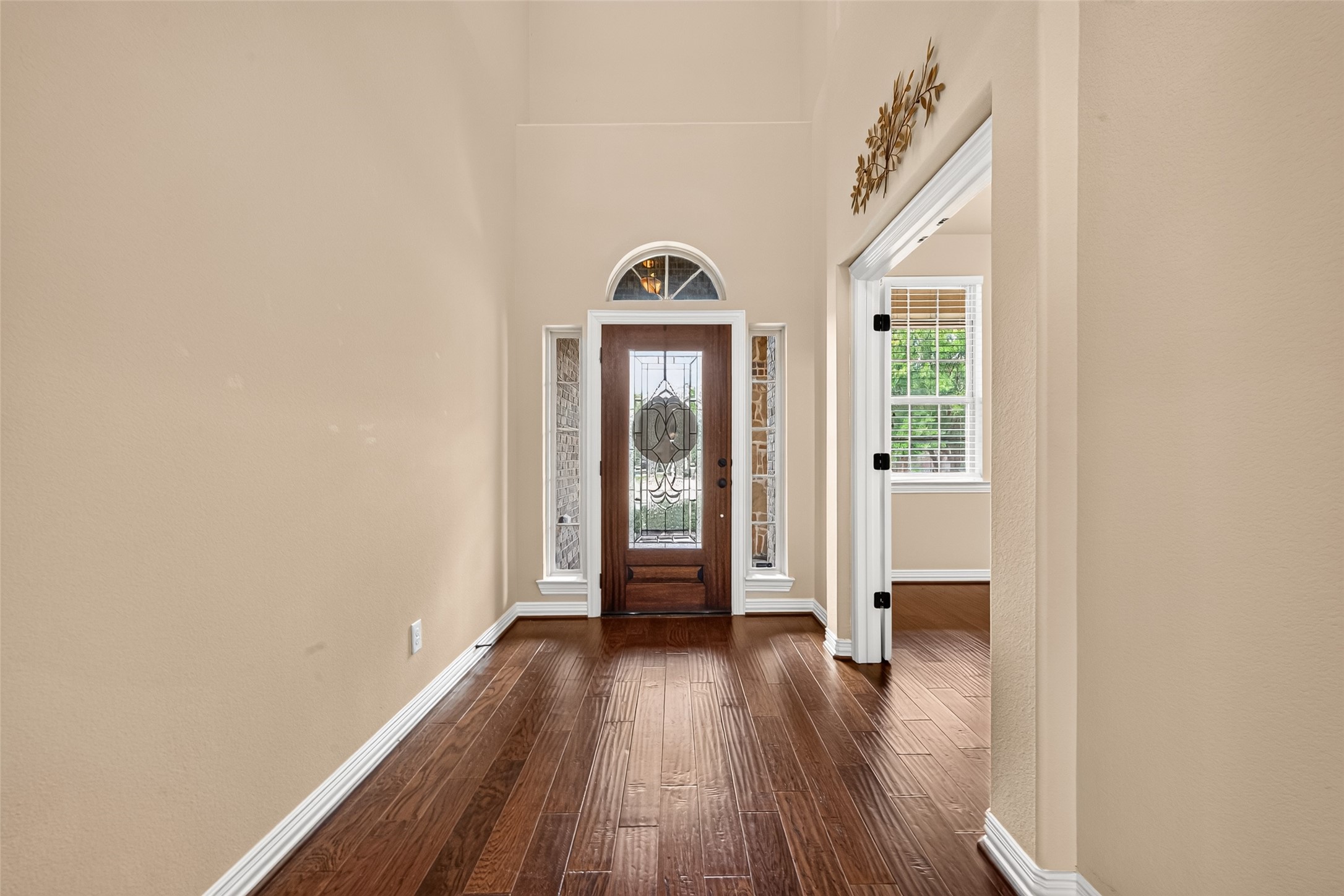 Step inside the foyer: engineered wood floors, hallway to the staircase