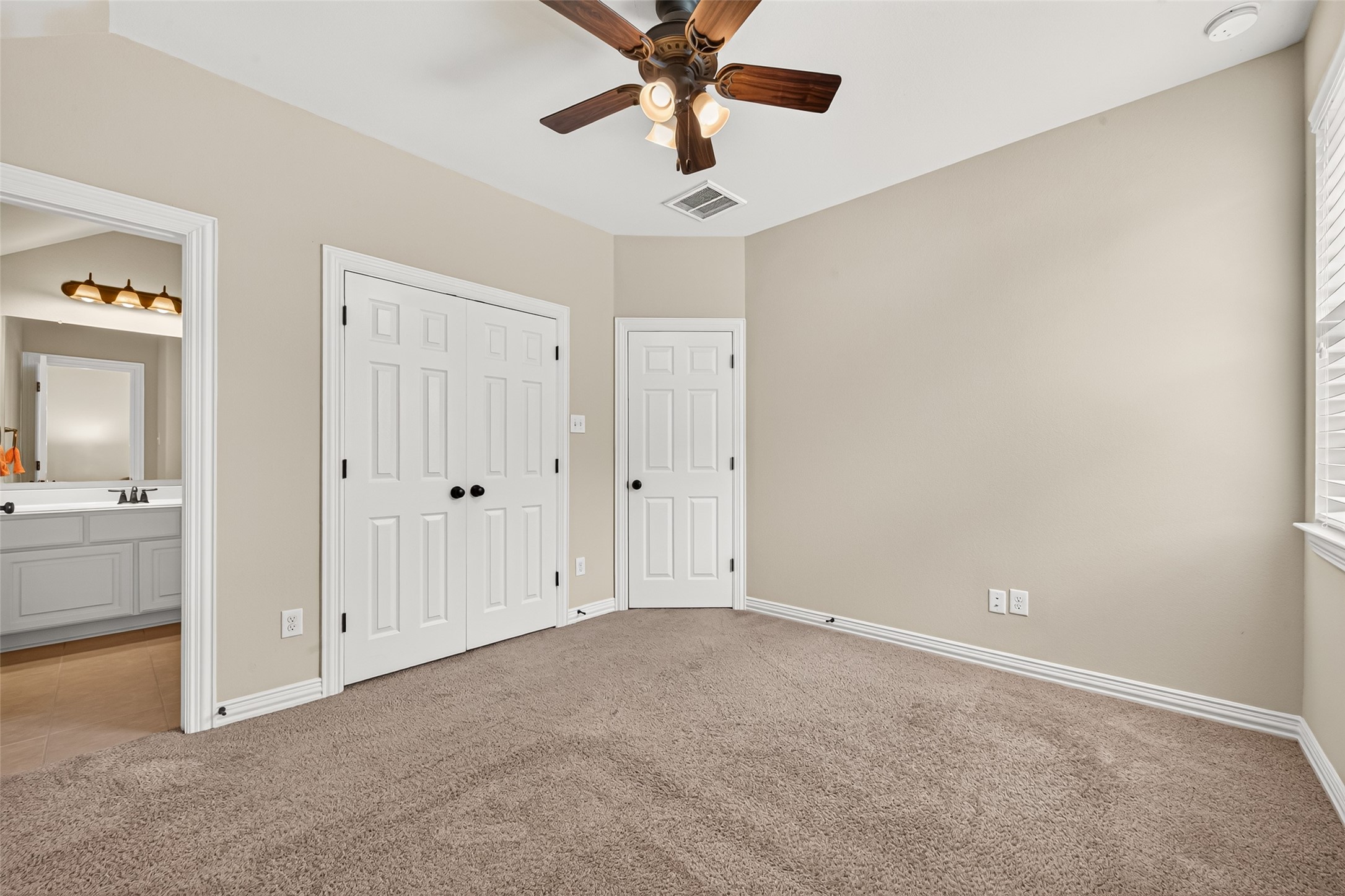 Bedroom with closet and bathroom entrance