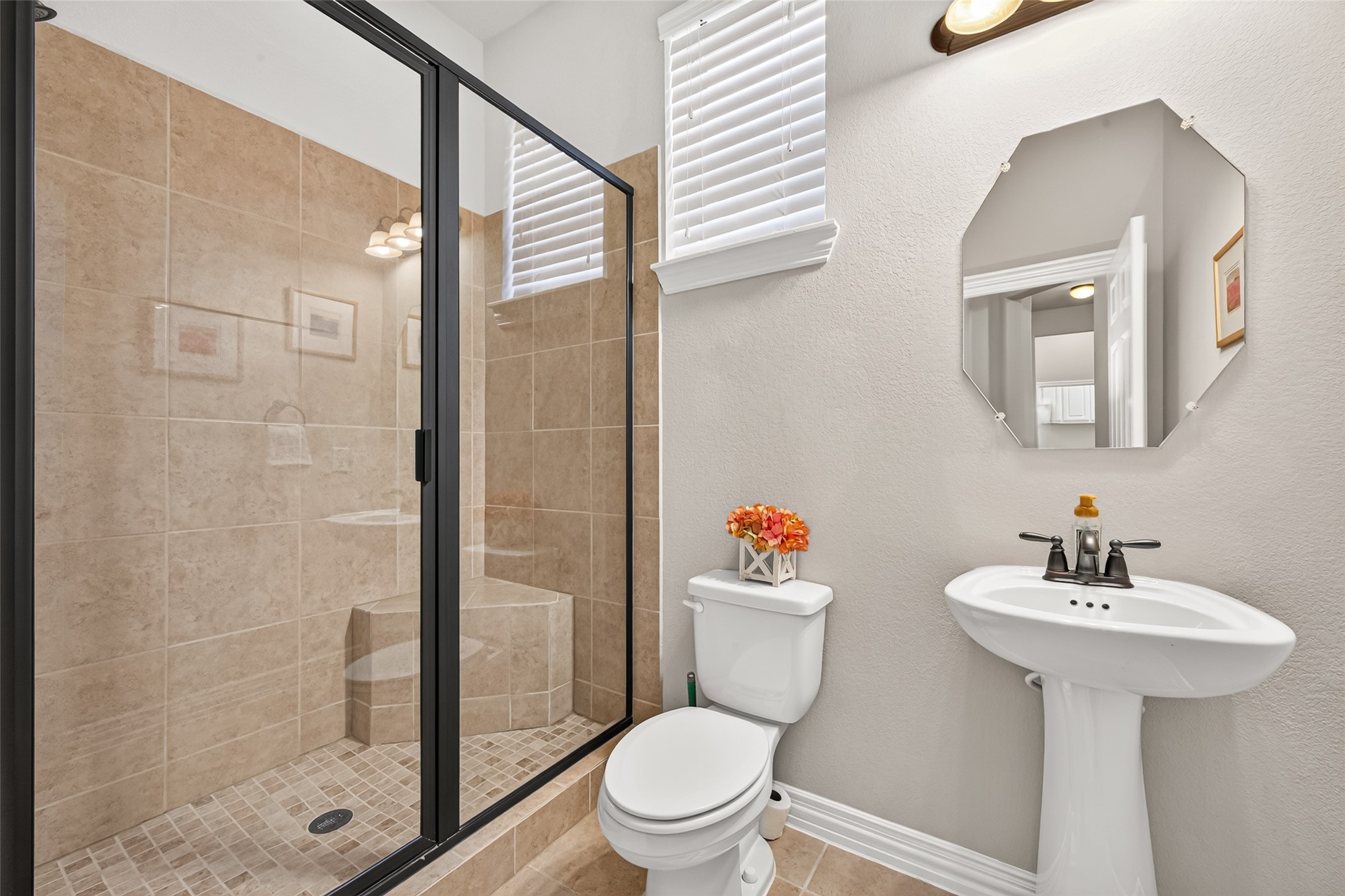 Guest bathroom with shower and pedestal sink