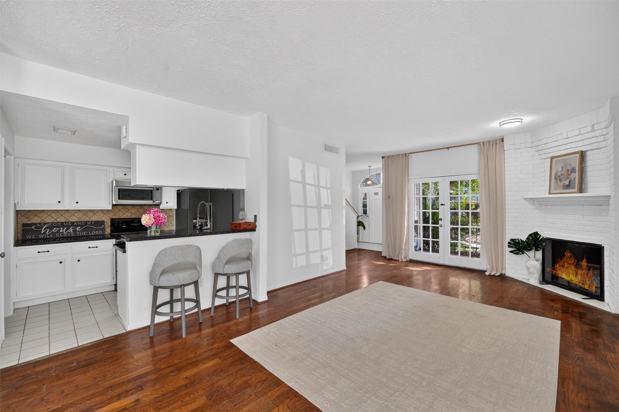Unstaged dining area with natural light and convenient access to the kitchen and living room.