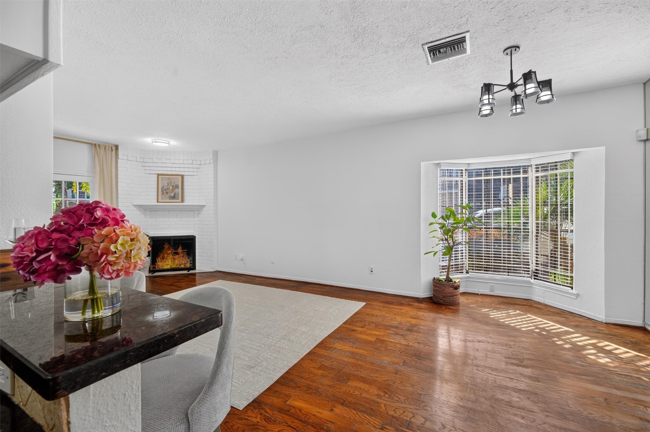 Unstaged dining area with natural light and convenient access to the kitchen and living room.