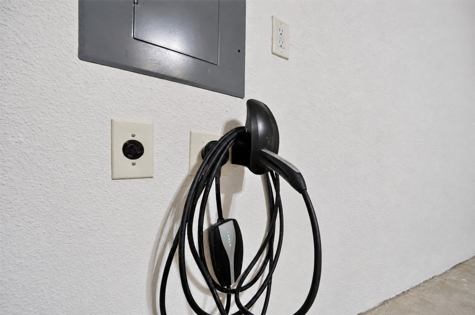 Garage EV charging outlet adds convenience for electric vehicle owners.