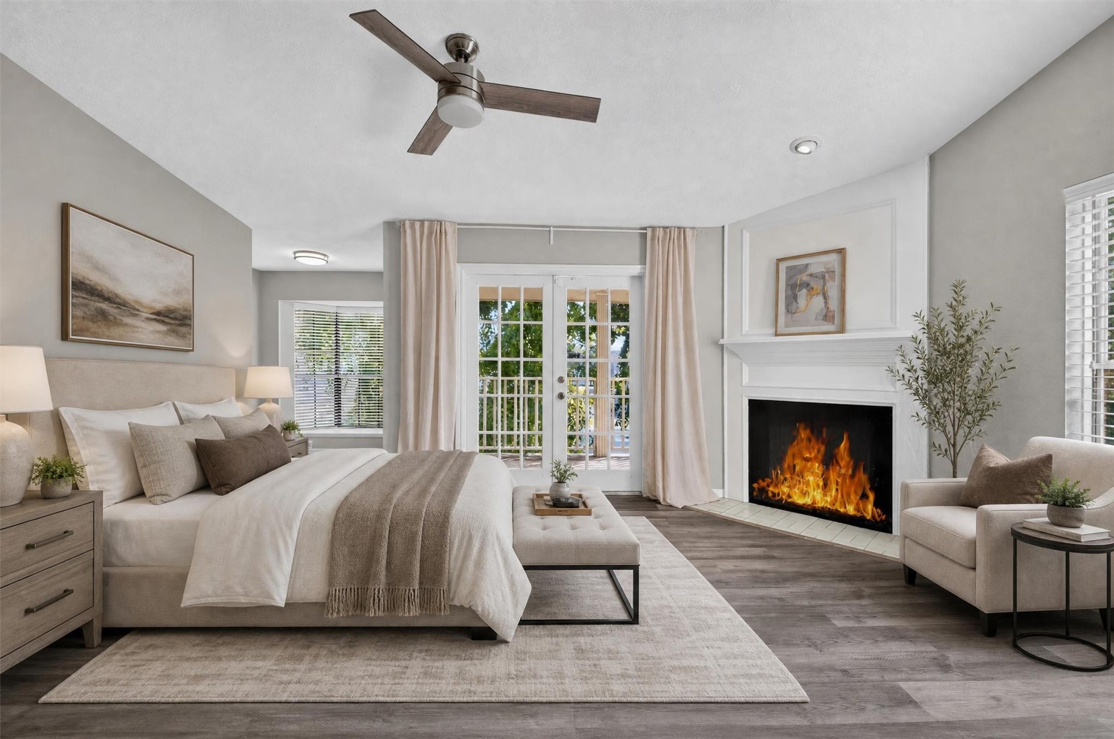Spacious primary suite featuring a fireplace and French doors opening to a covered balcony overlooking mature trees and the community pool. Virtually staged.