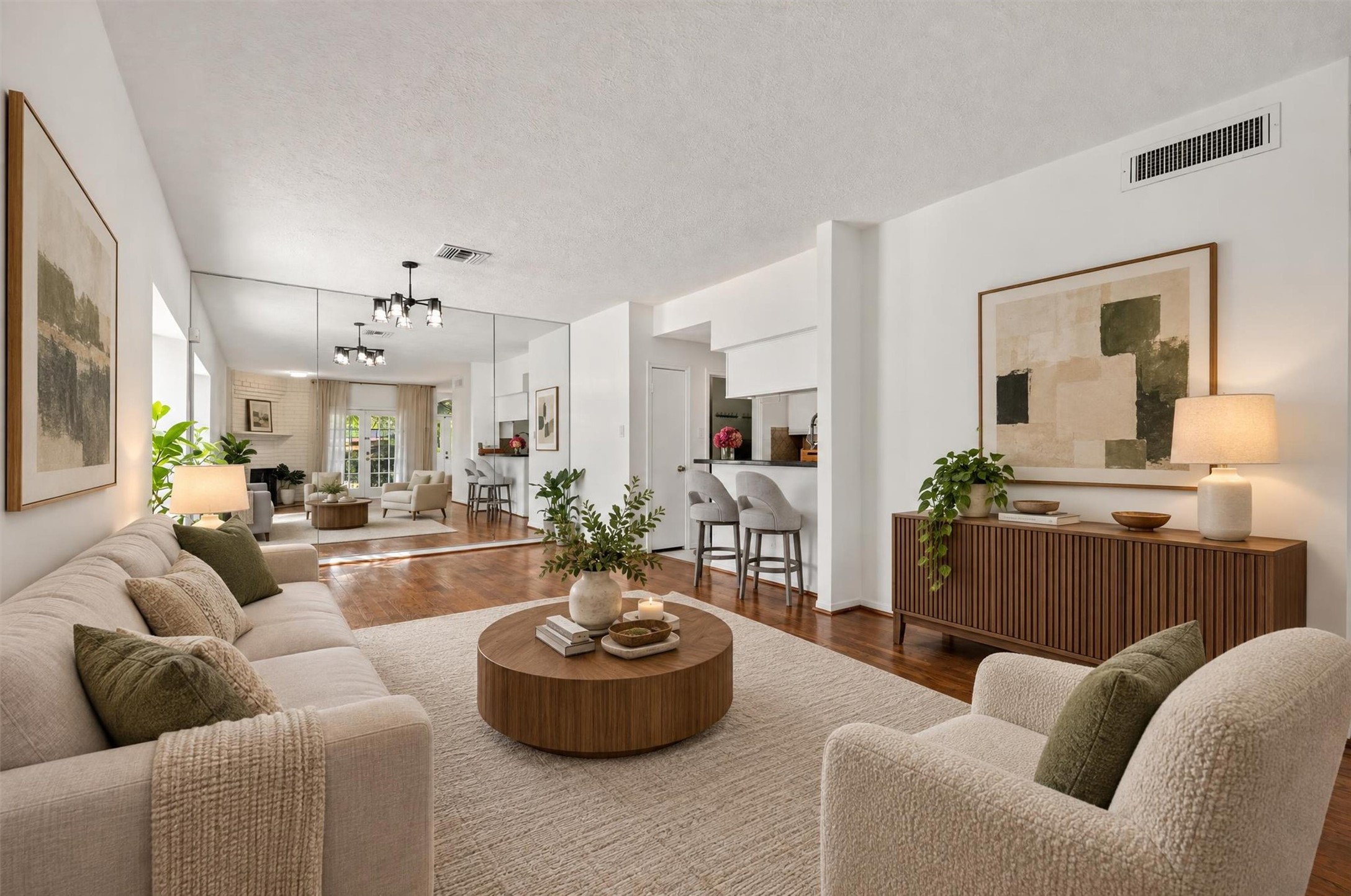 An alternate view of the living room showcasing the flow toward the dining area and kitchen. Virtually staged.