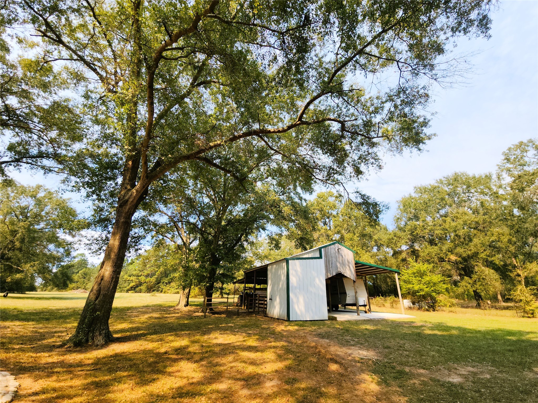 Charming property featuring a spacious yard with mature trees and a versatile barn, with a tack room, loft and lean-to.