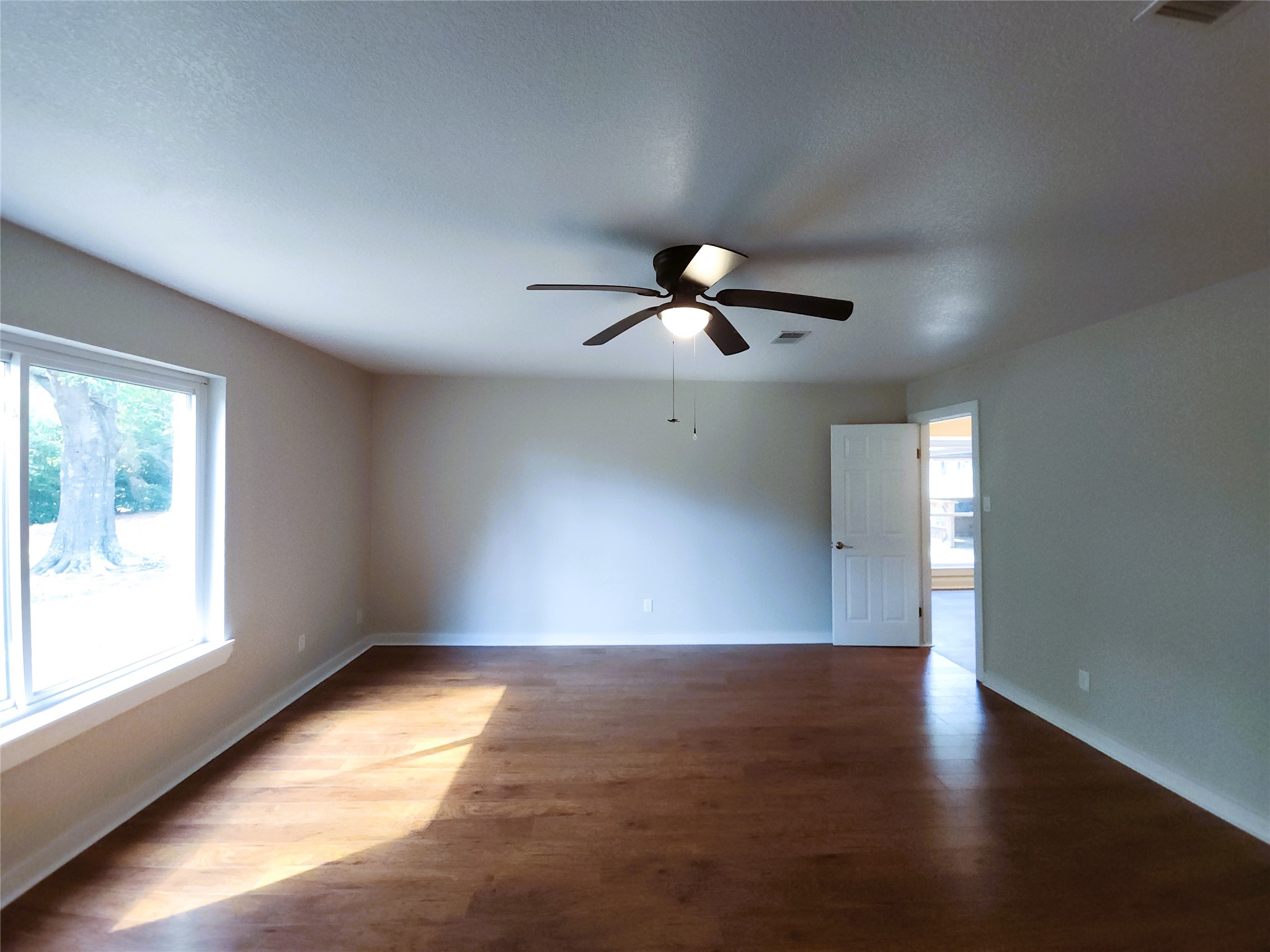This primary bedroom is large with an attached bathroom including dual closets and a walk-in shower.