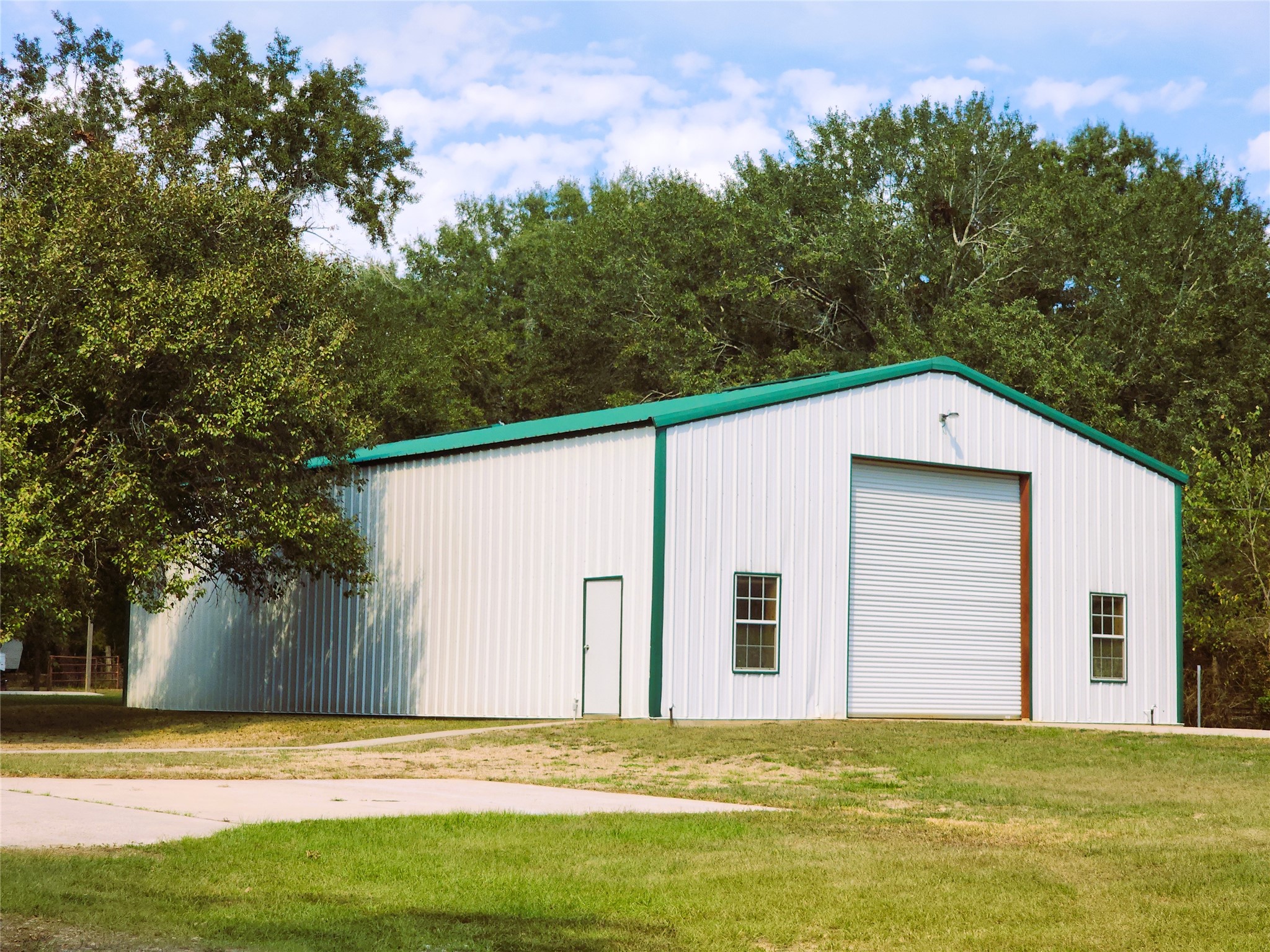 2400 sq ft metal building featuring a 14'x14' roll-up door at each end, windows for natural light, and a mezzanine spanning the entire length of the building. 2400 sq ft metal building featuring a 14'x14' roll-up door at each end, windows for natural light, and a mezzanine spanning the entire length of the building.