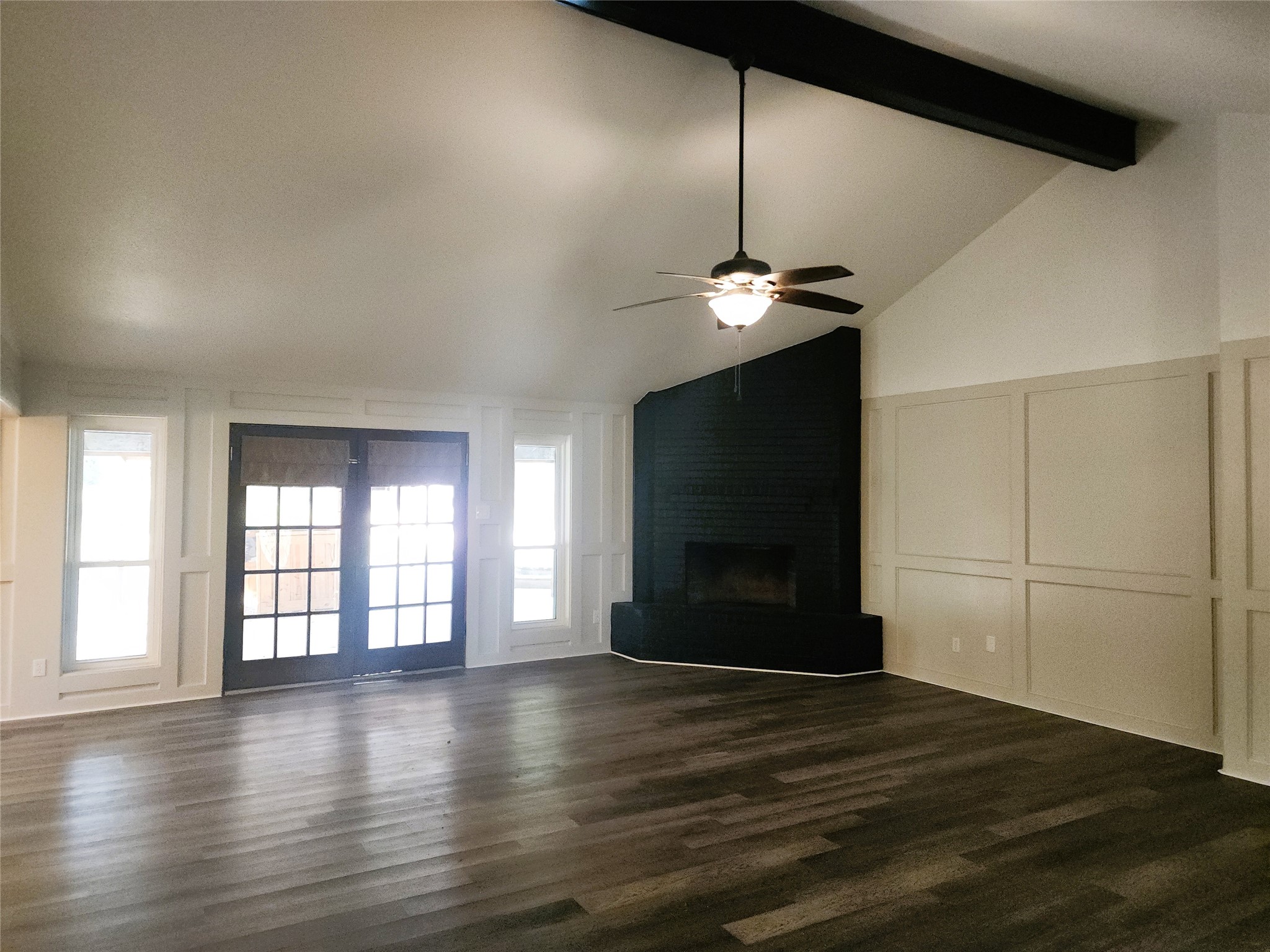 Living room with French doors leading out to the covered patio and pool area. Living room with French doors leading out to the covered patio and pool area.