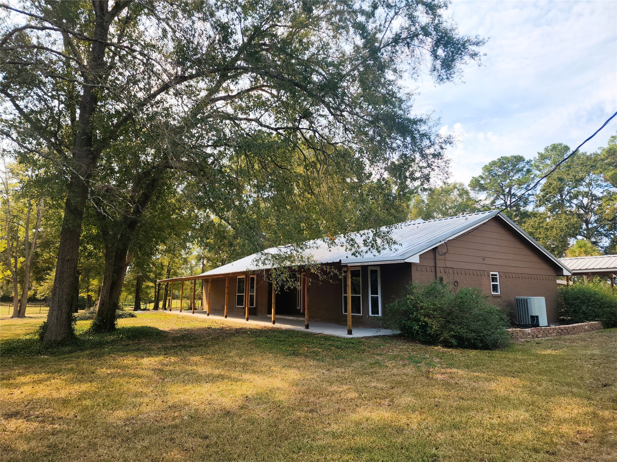65'x9x covered front porch with views of the pond across the street.