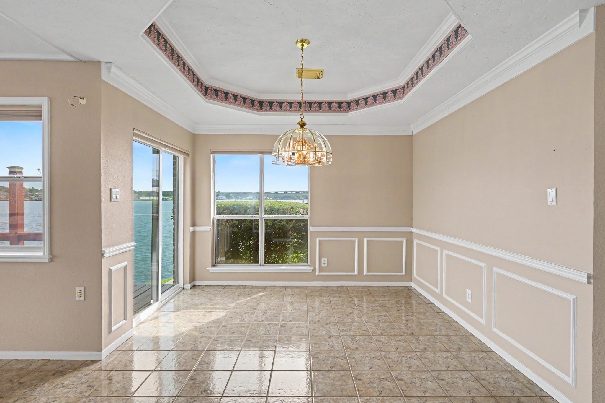 Dining Room complete with tray ceiling, chair railing and wainscoting. Sliding glass door leads to wrap around porch- a perfect spot for a grill! Dining Room complete with tray ceiling, chair railing and wainscoting. Sliding glass door leads to wrap around porch- a perfect spot for a grill!