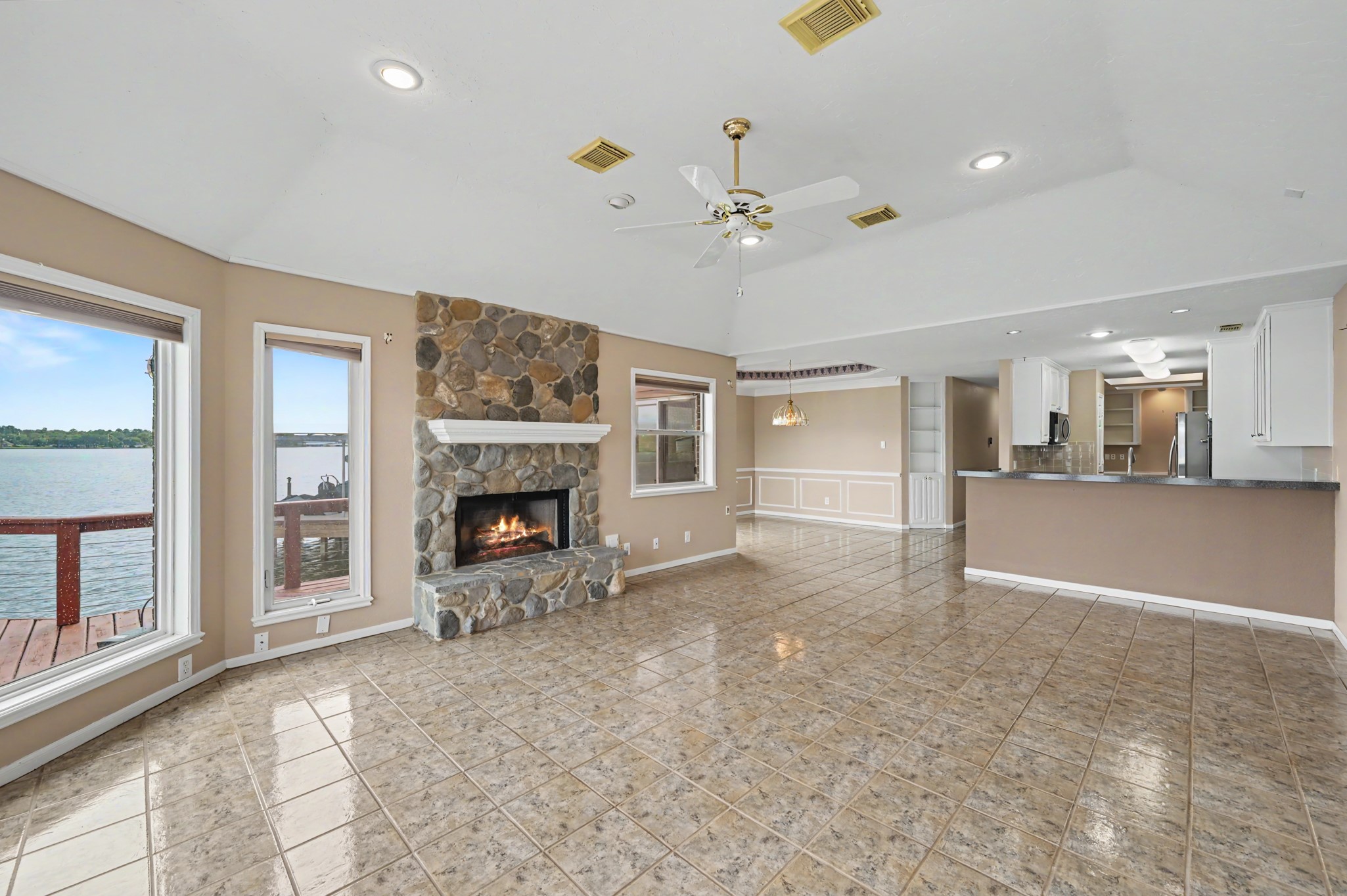 Living Area with focal point Fire Place  surrounded by windows with a view.