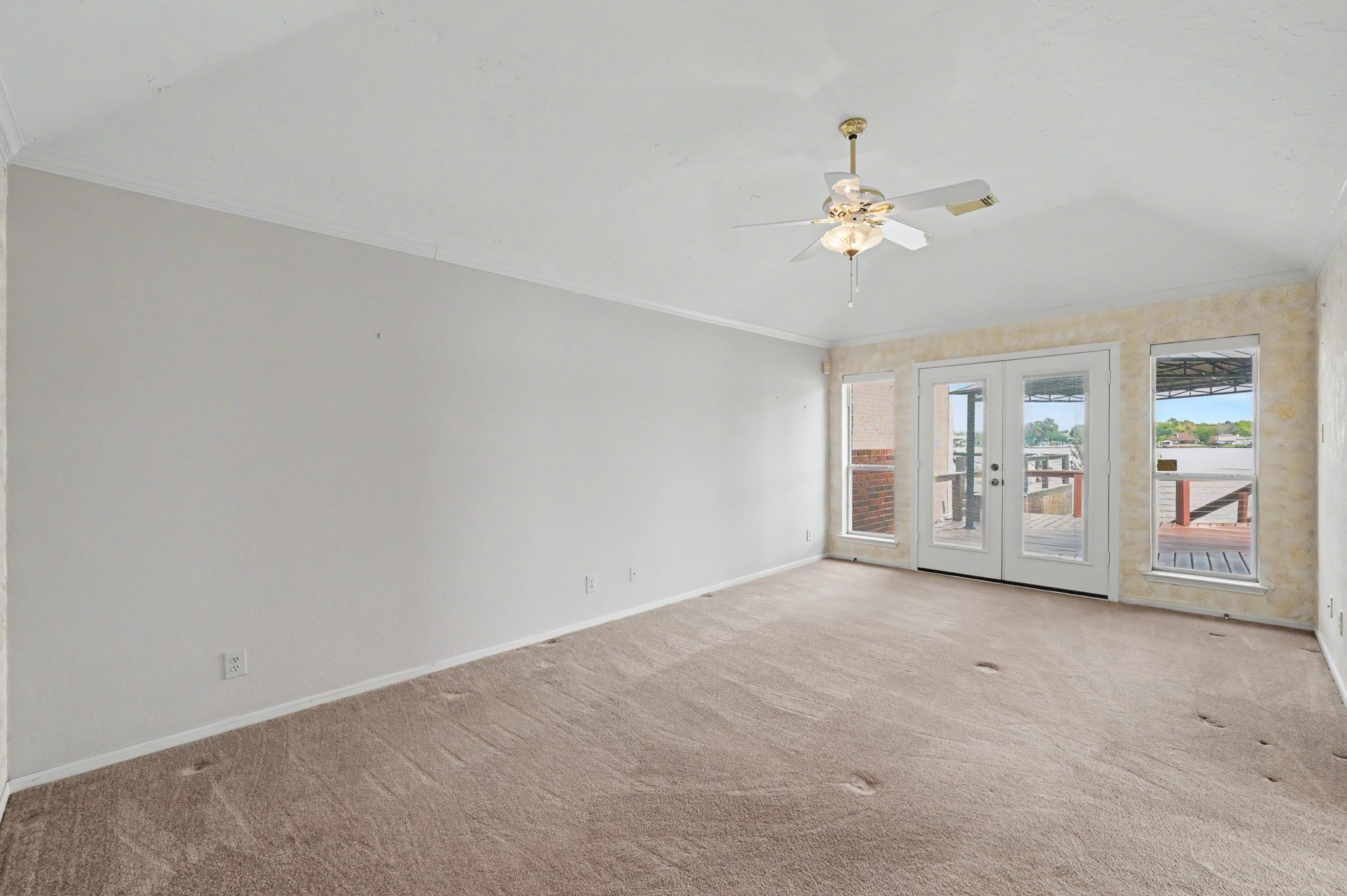 Spacious Primary Suite with French Doors leading to the deck.