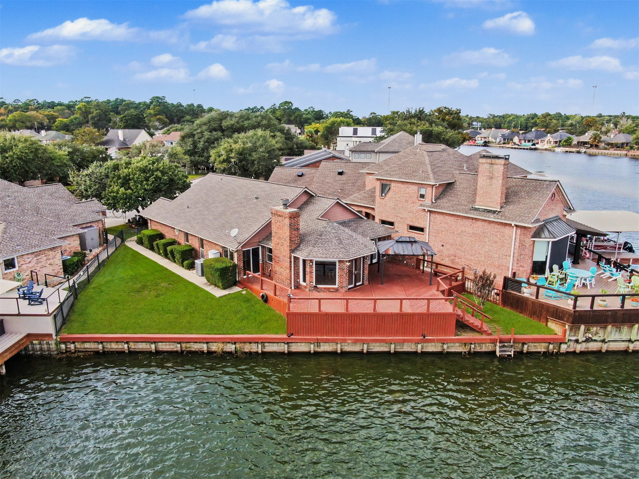Aerial view highlighting the lakefront home.