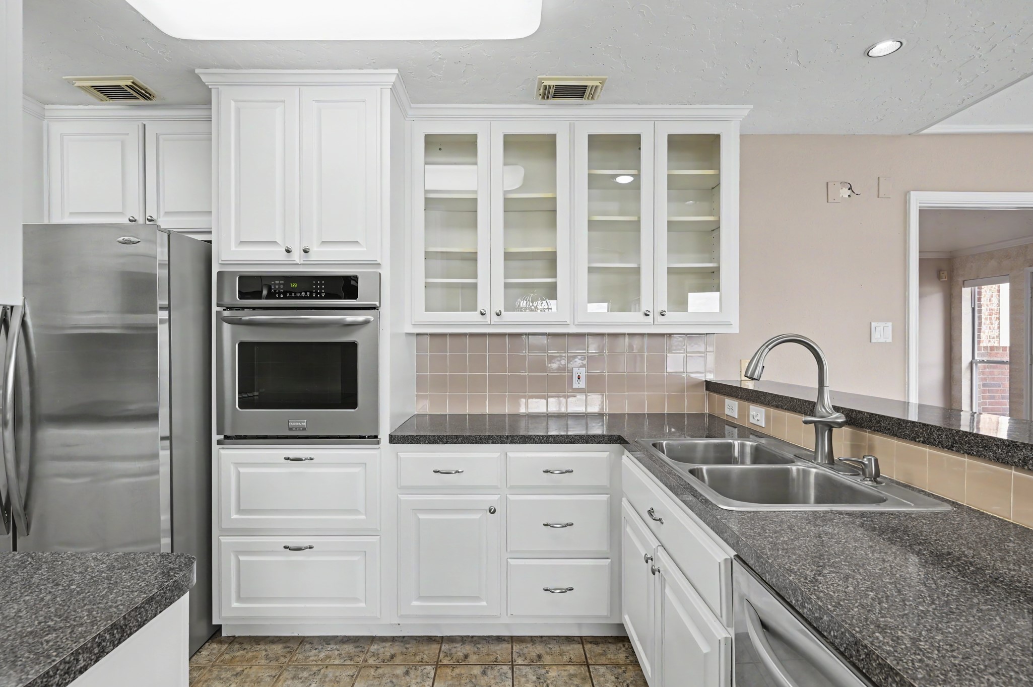 Freshly painted cabinets with stainless appliances