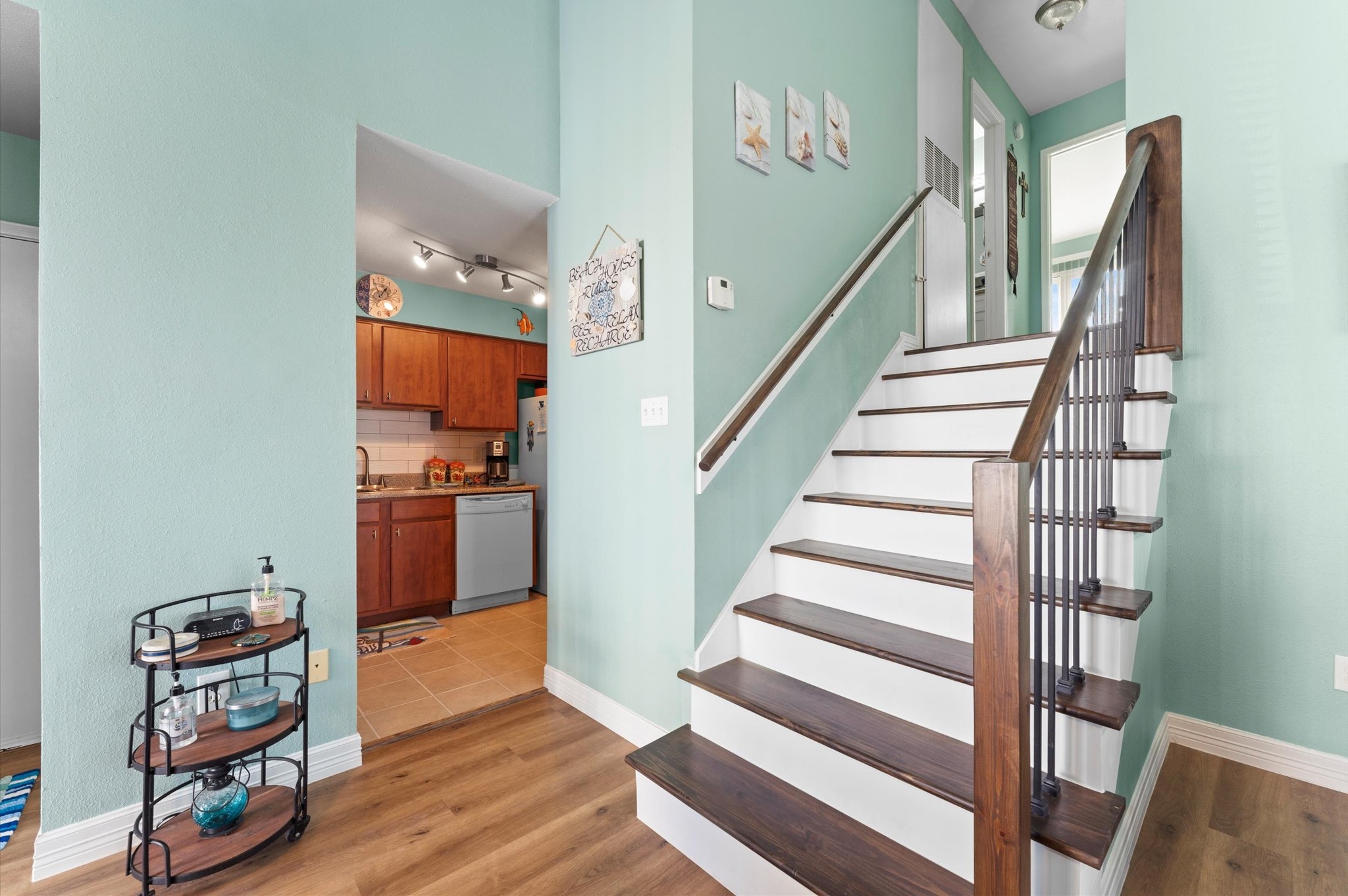 The flooring, stairs, railing, wet bar area, and bathroom were all updated in 2026, along with fresh paint throughout.