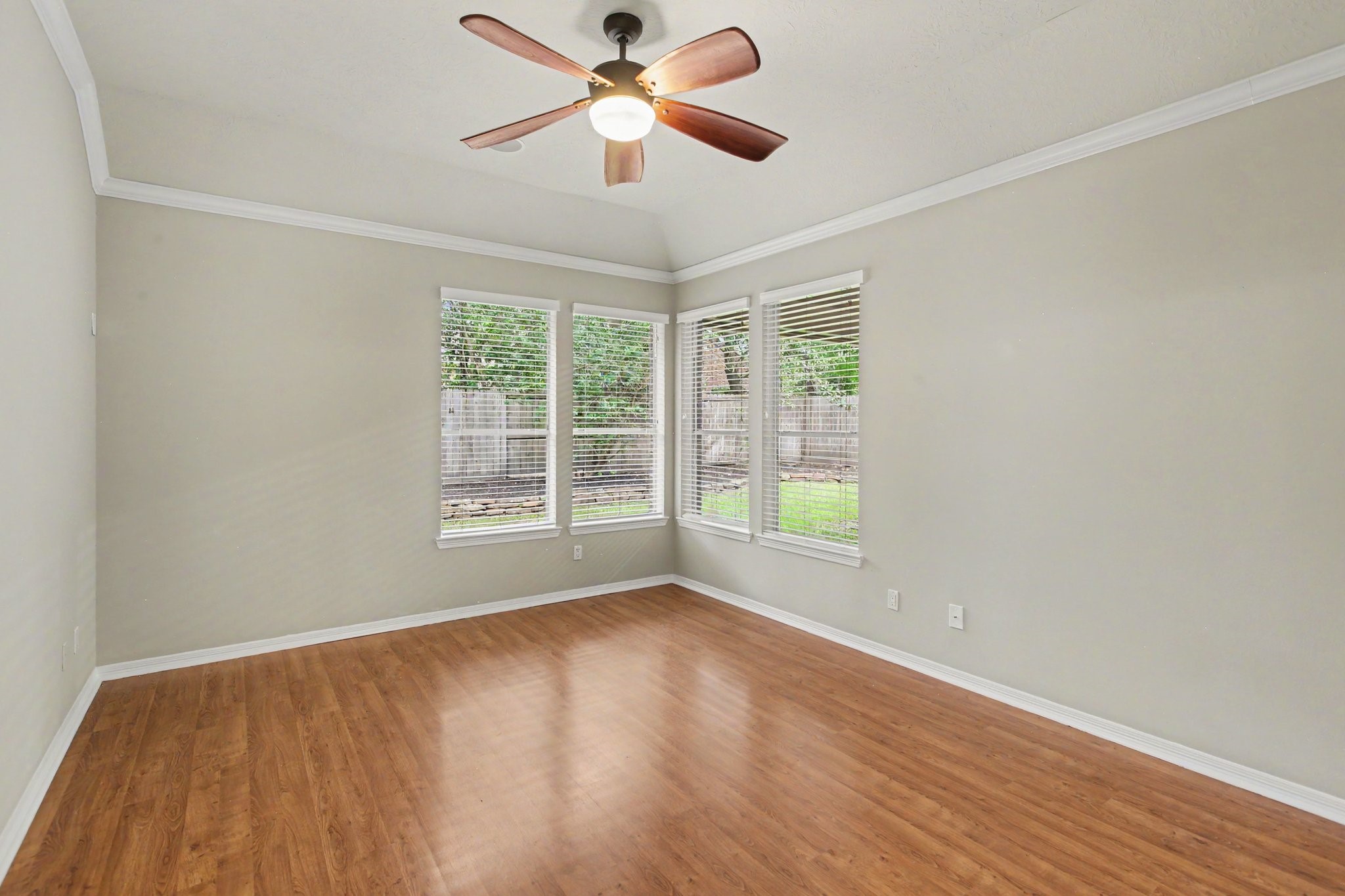 The tucked away Owner's Suite with a high ceiling is spacious and bright with beautiful views of the outdoors.