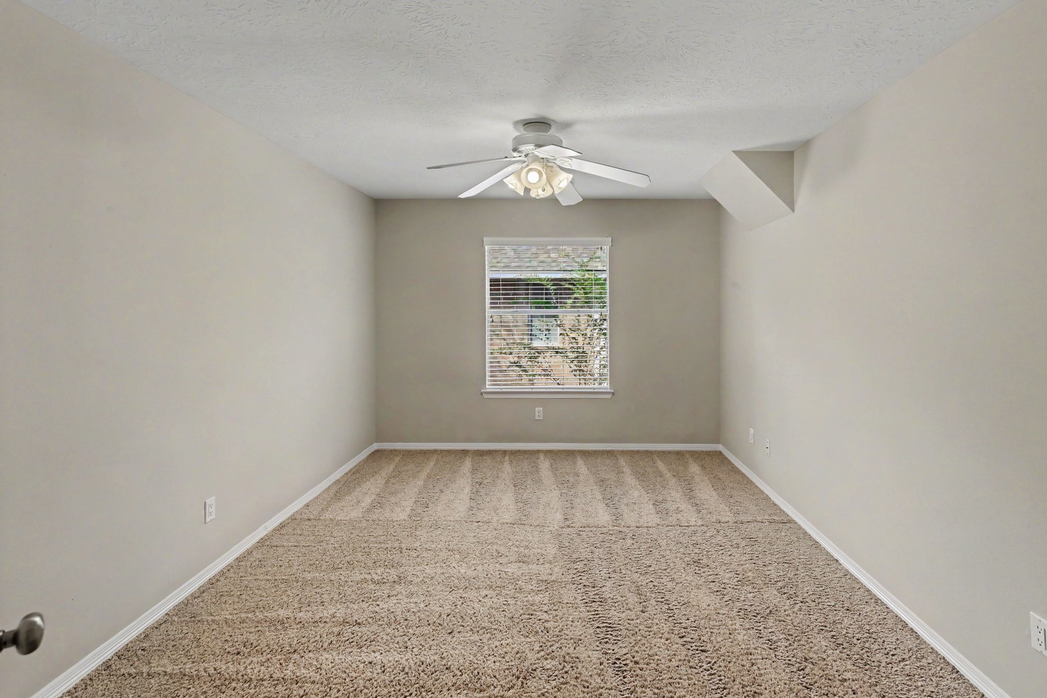 The third secondary bedroom upstairs has carpet, a ceiling fan and built-in shelves. The expanded closet with storage has a full size mirror, a built-in desk and access to attic storage.